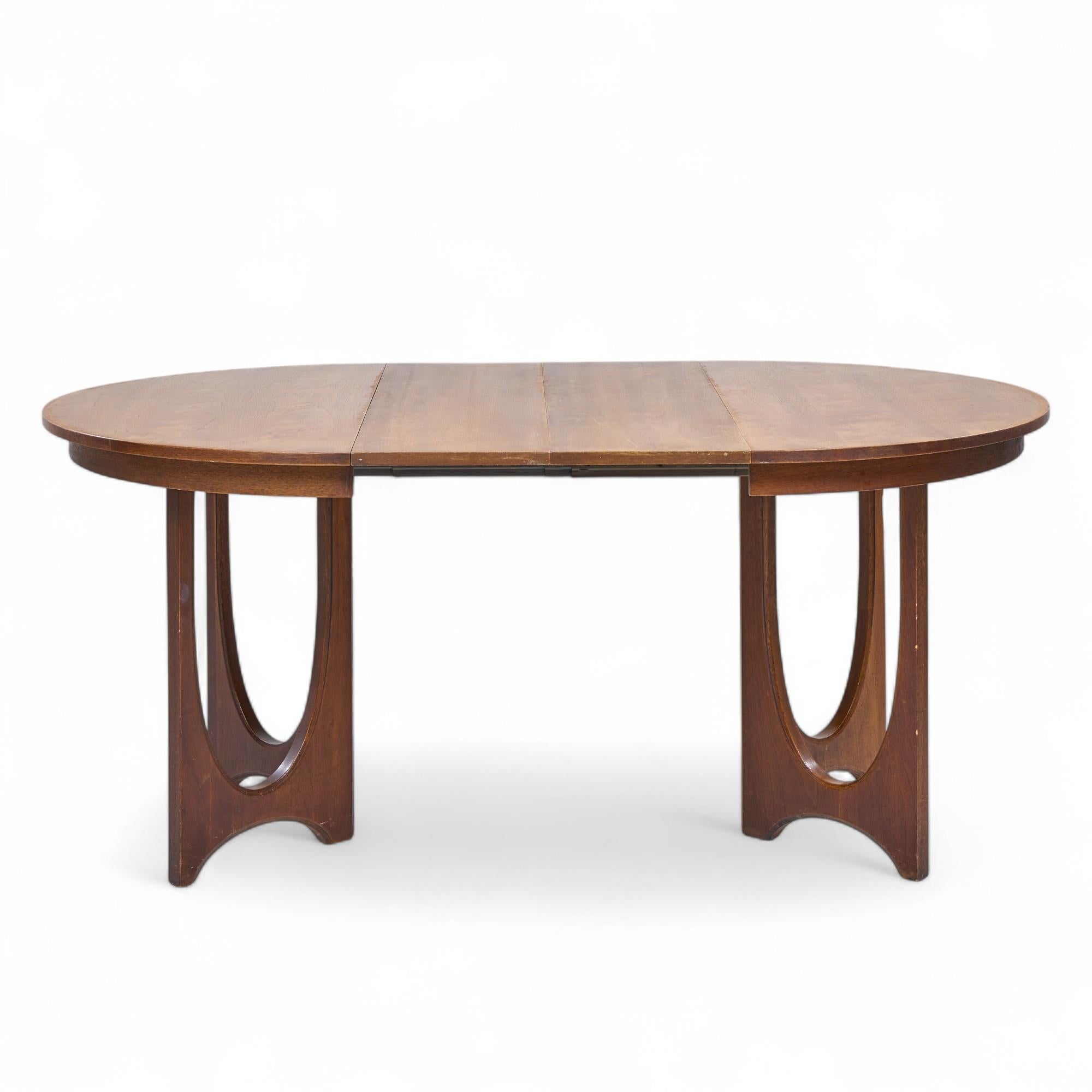 Broyhill Brasilia Mid Century Walnut Expanding Dining Table with 2 Leaves

This table measures: 44.25 wide x 44 deep x 29.75 inches high, with a chair clearance of 26.75 inches, each leaf measures 12 inches wide, making a maximum table width of