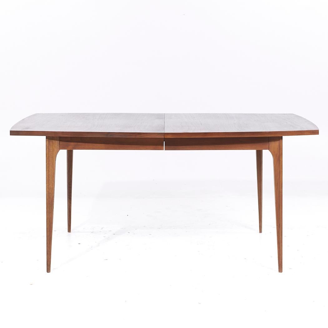 Broyhill Brasilia Mid Century Walnut Expanding Dining Table with 3 Leaves

This table measures: 65.75 wide x 40.25 deep x 29.75 inches high, with a chair clearance of 25.5 inches, each leaf measures 12 inches wide, making a maximum table width of