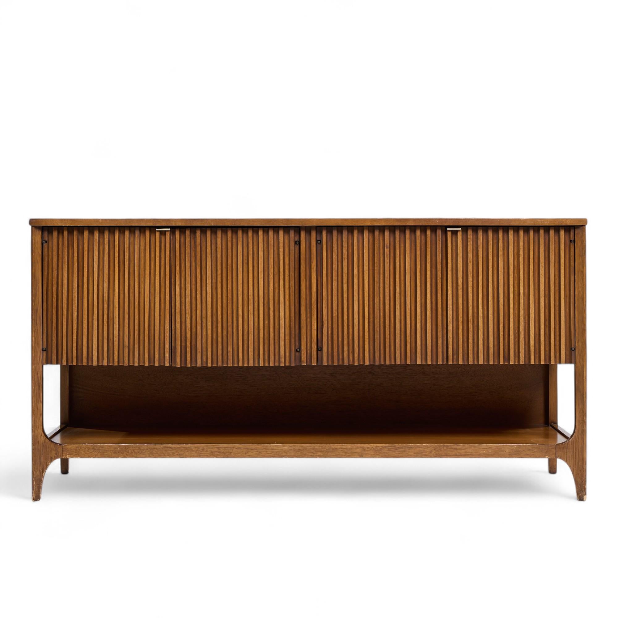 Broyhill Brasilia Mid Century Walnut Fluted Credenza

This credenza measures: 60 wide x 19 deep x 30.5 inches high

All pieces of furniture can be had in what we call restored vintage condition. That means the piece is restored upon purchase so it’s