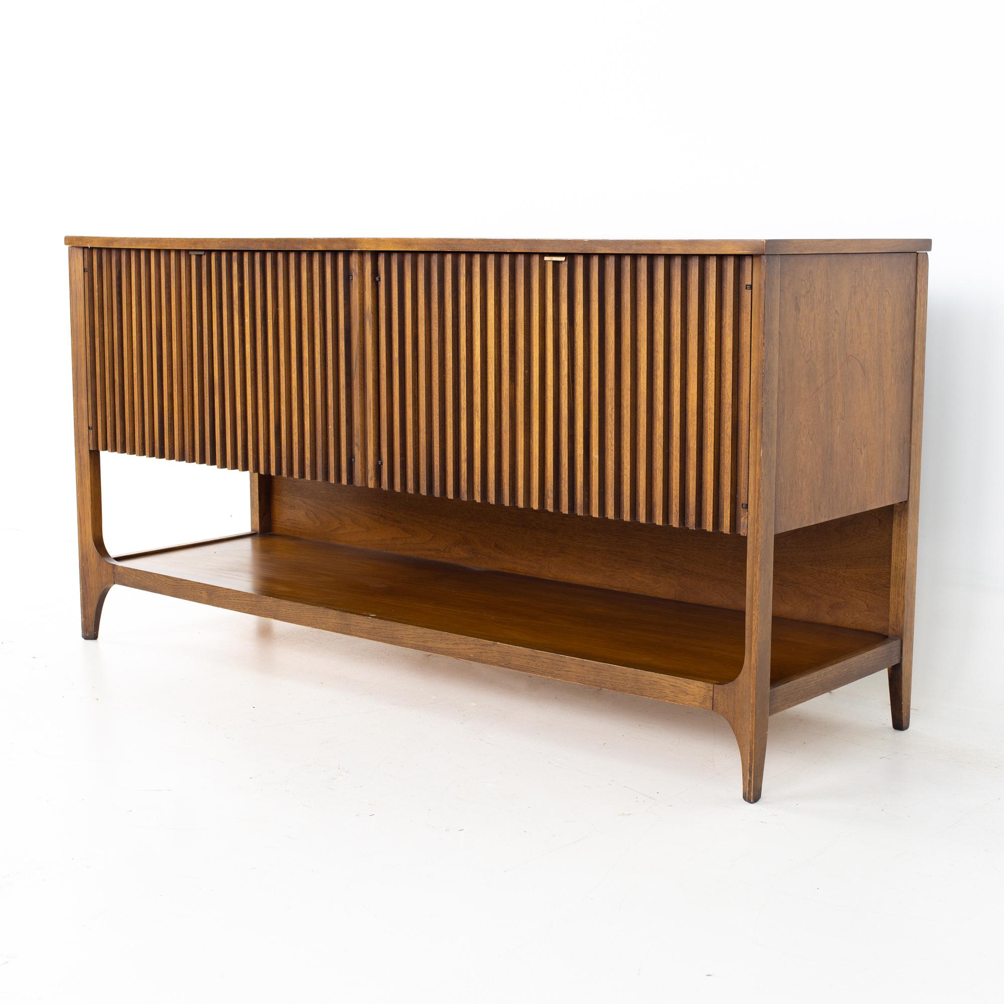 Broyhill Brasilia mid century walnut louvered credenza
Credenza measures: 60 wide x 19 deep x 24.5 inches high 

All pieces of furniture can be had in what we call restored vintage condition. That means the piece is restored upon purchase so it’s