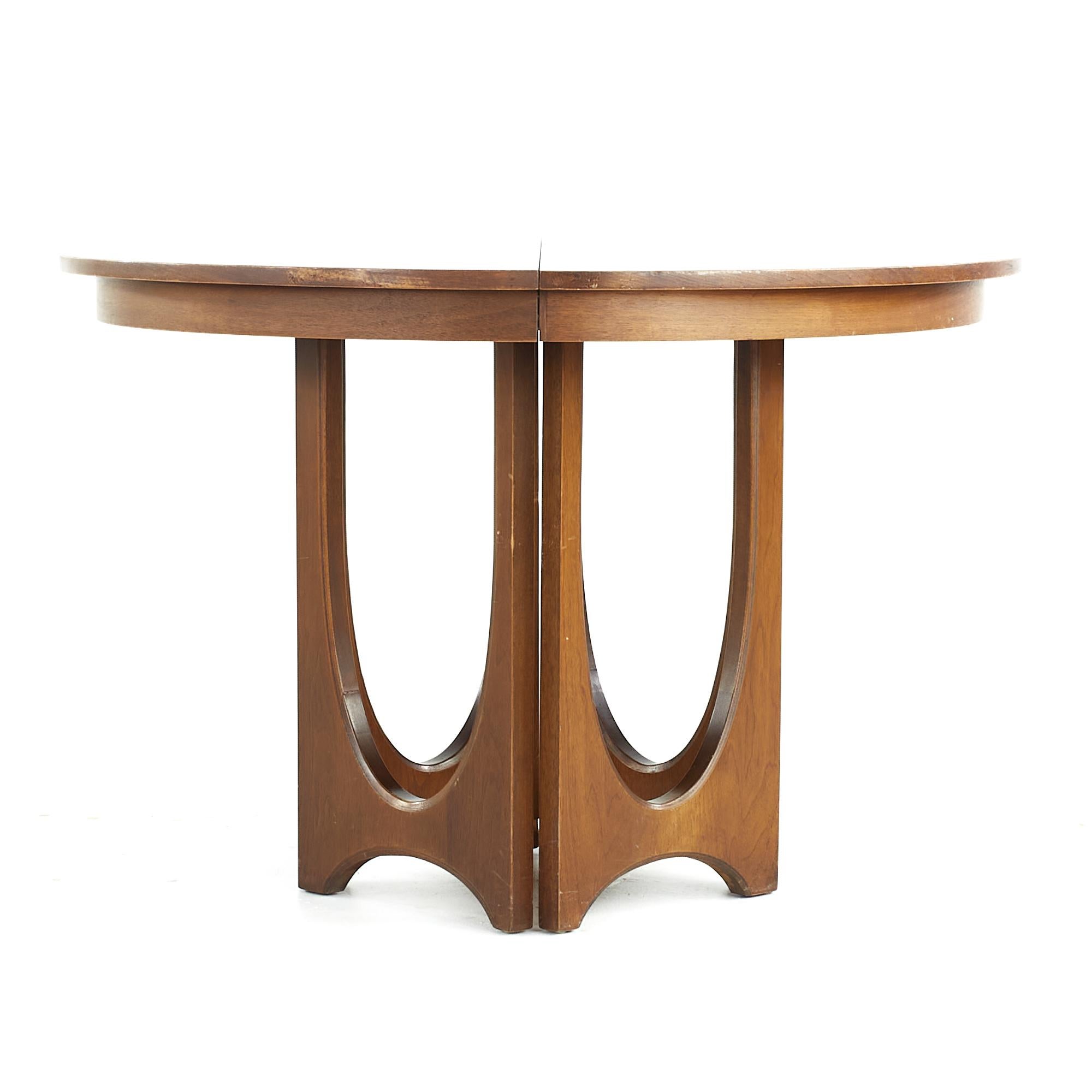 Broyhill Brasilia midcentury Walnut pedestal table with 3 leaves

This table measures: 44.25 wide x 44 deep x 29.75 high, each leaf measures 12 inches wide, making a maximum table width of 80.25 inches when all leaves are used

All pieces of