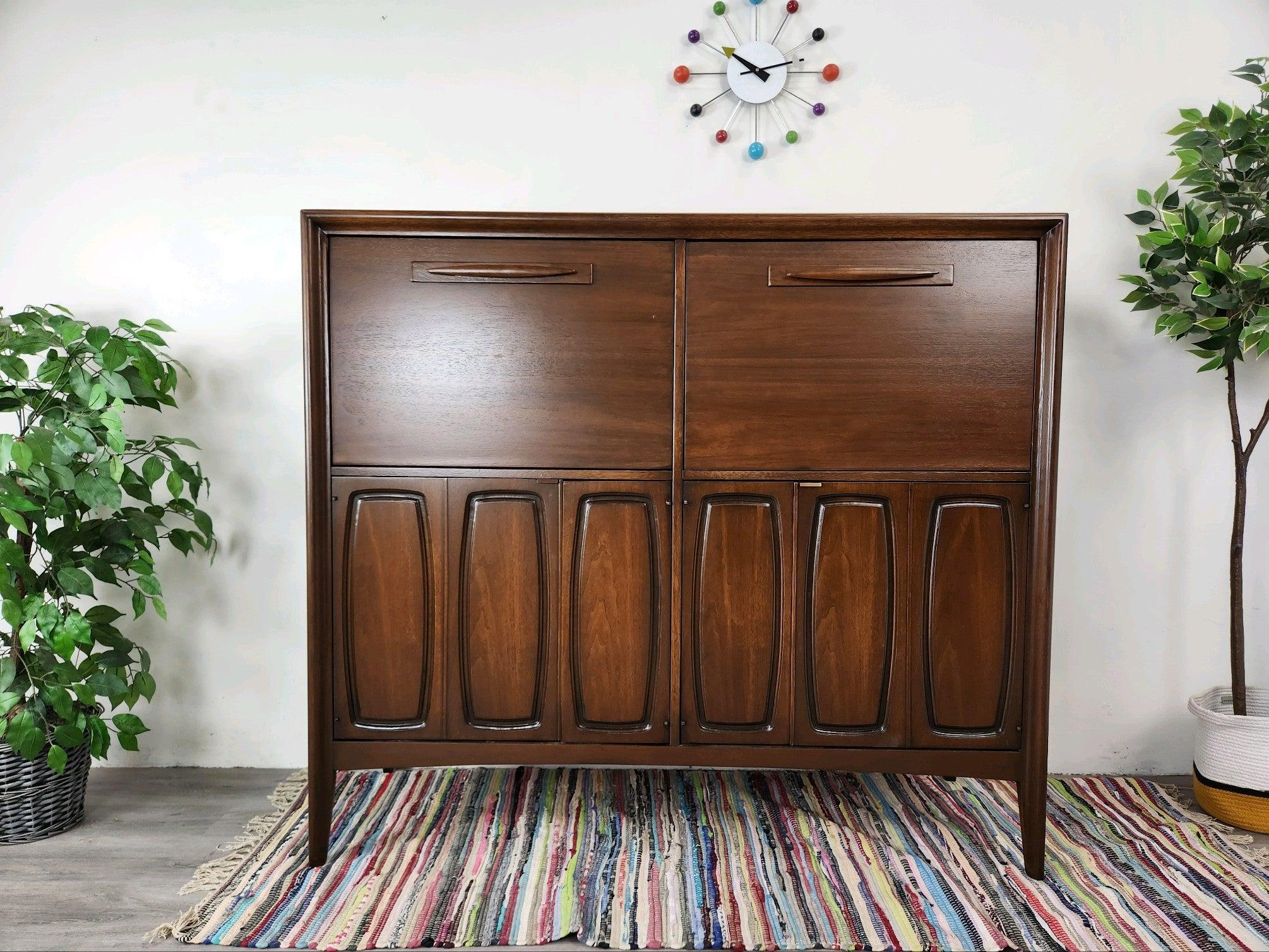 This Broyhill piece was purchased from the family of the original owner. It was called a Butlers Pantry in the catalog but it was used as a desk by the owner. It's the perfect size for a bar cabinet too so you have so many options. 
There are
