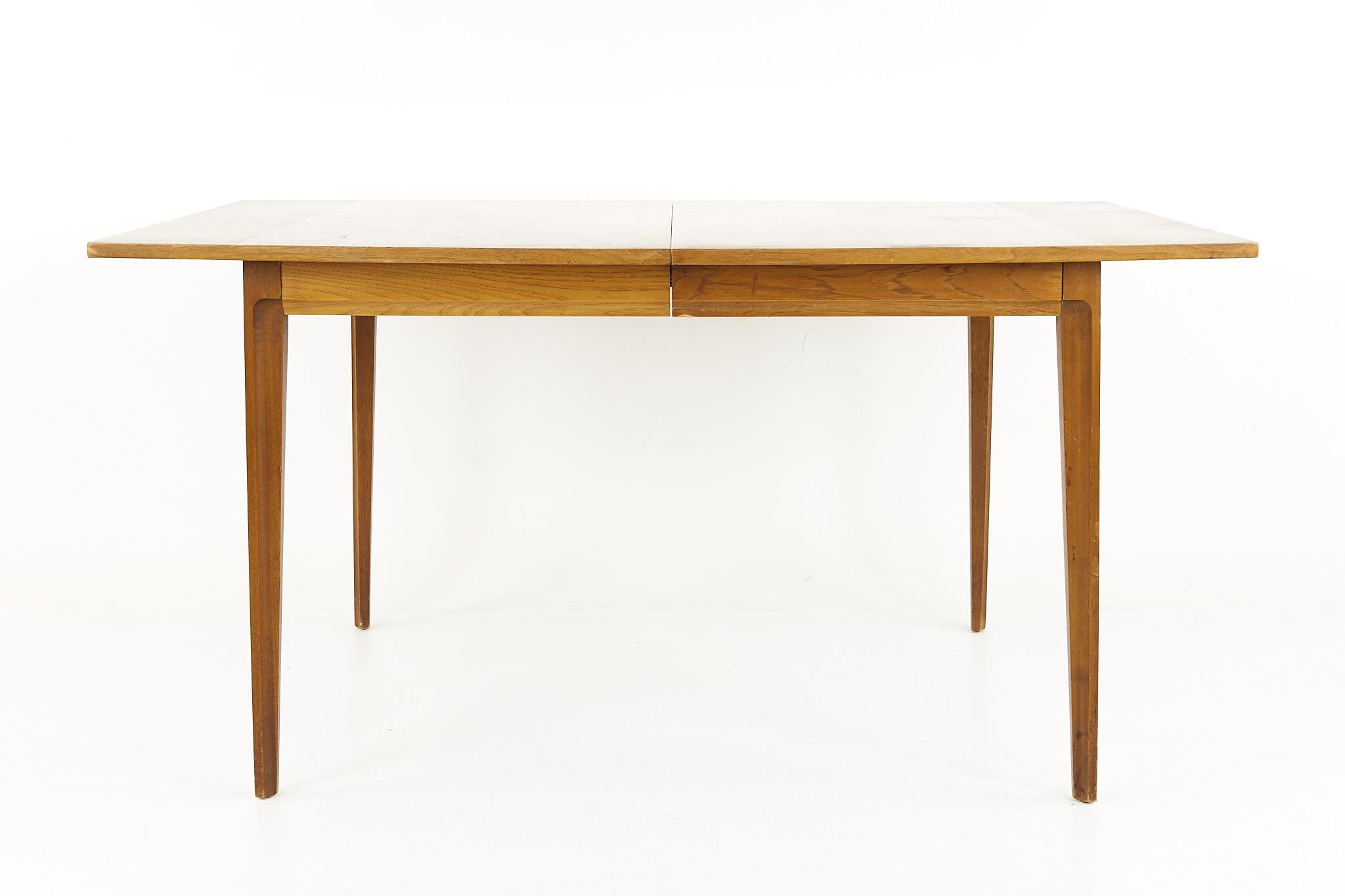 Broyhill forward '70 mid century walnut dining table with 1 leaf

This table measures: 60 wide x 40.5 deep x 30 inches high, with a chair clearance of 29 inches, the leaf measures 12 inches wide, making a maximum table width of 82 inches

All