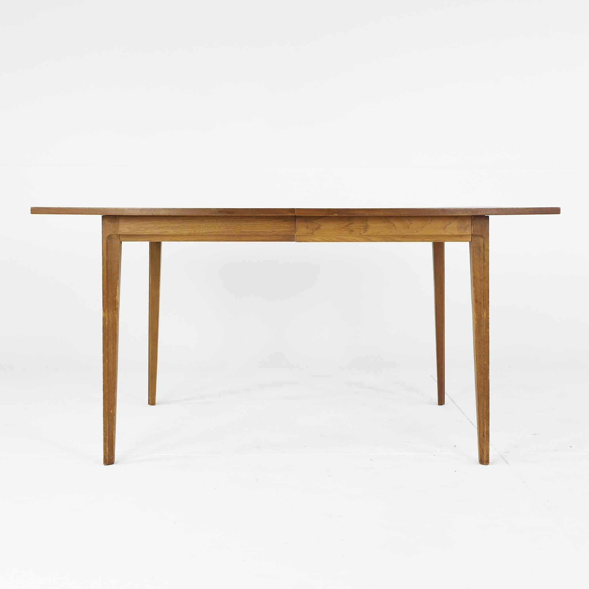 Broyhill forward 70 mid century walnut dining table with one leaf

This table measures: 60 wide x 40 deep x 30 inches high; with a chair clearance of 26 inches, the leaf measures 12 inches wide, making a maximum table width of 72 inches when the