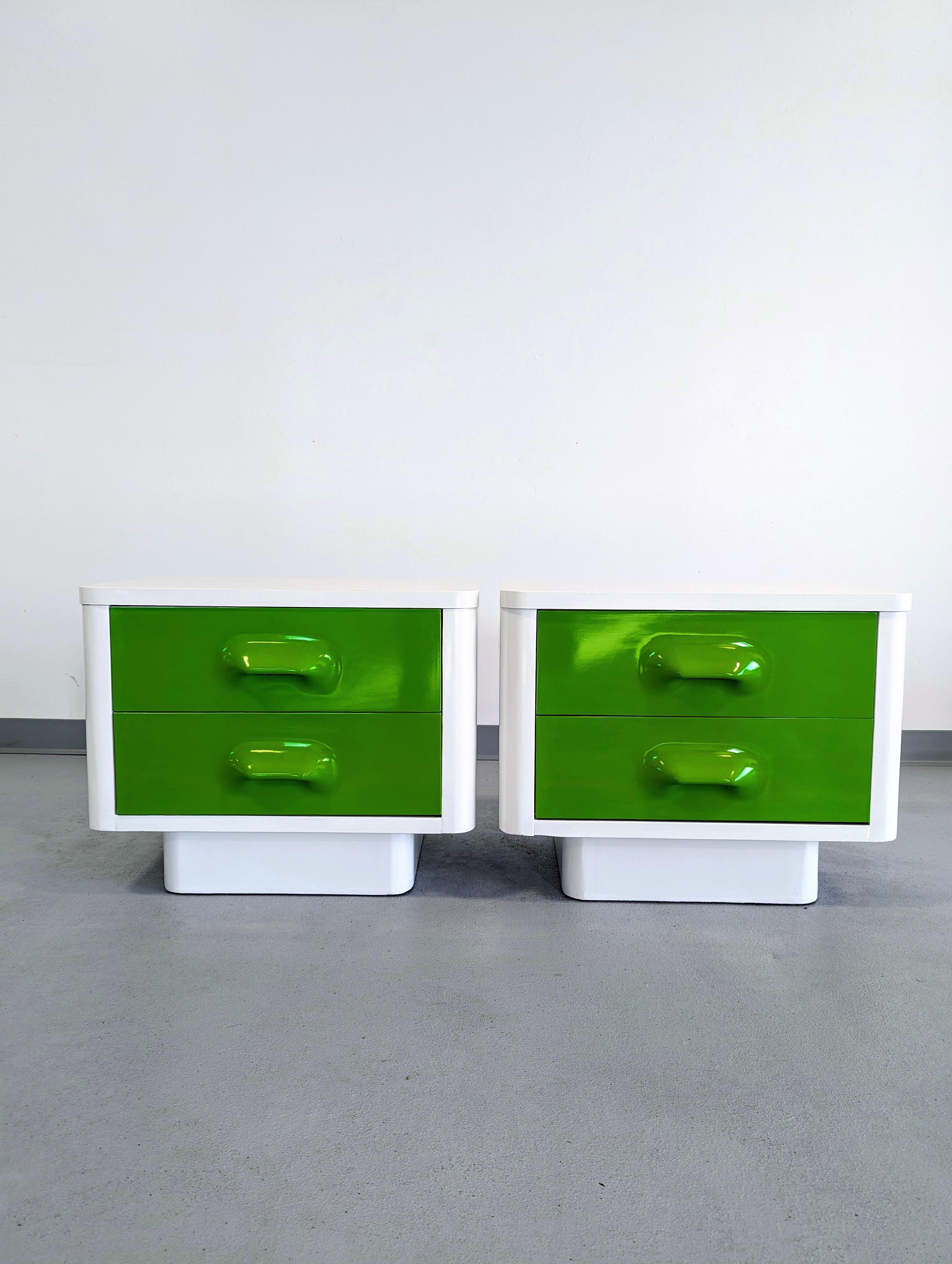 Broyhill Premier nightstands from the Chapter One furniture collection. The nightstands have a white painted wood case with radius corners and a recessed plinth. Green mold-injected ABS drawer fronts. Stamped 