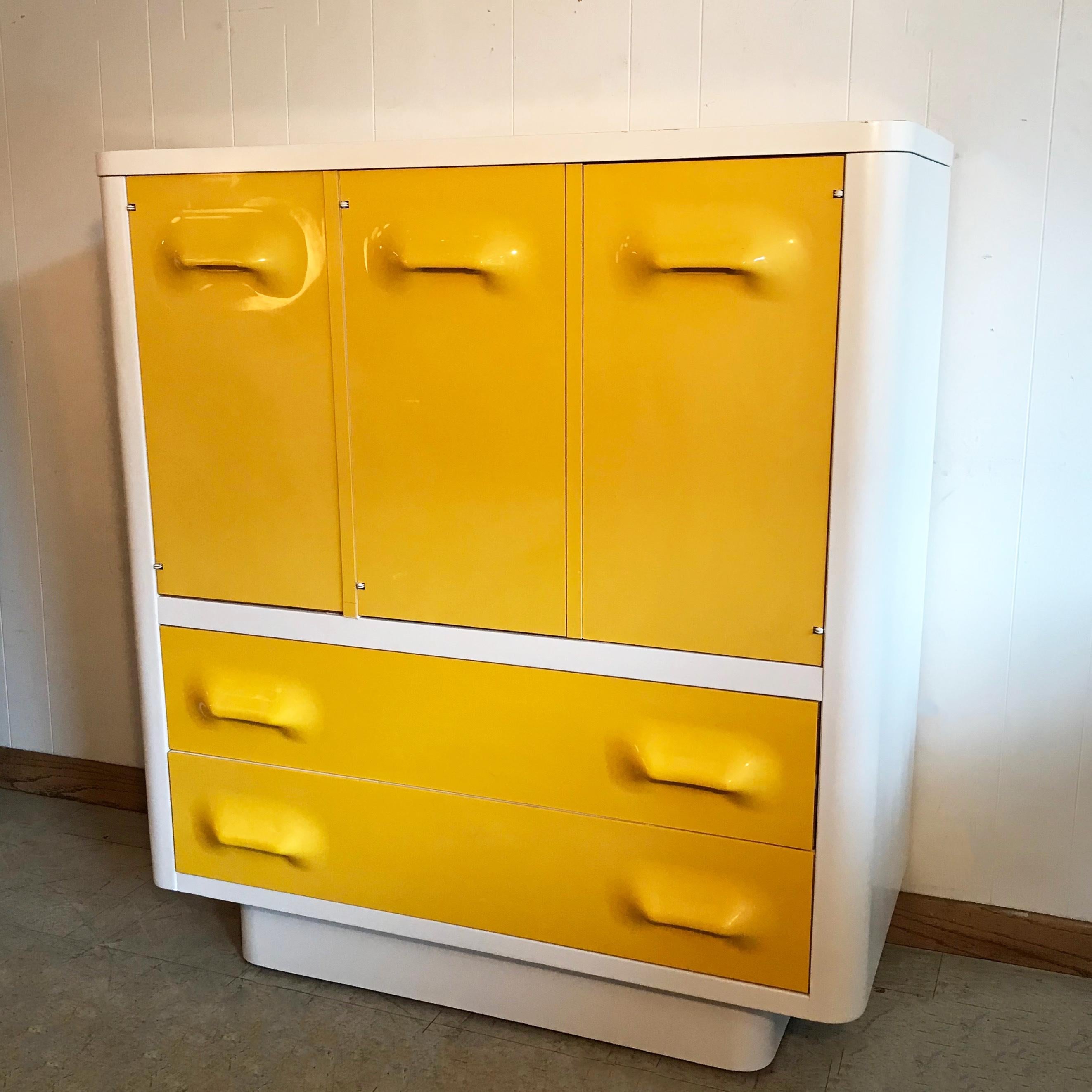 Mid-Century Modern, highboy dresser by Broyhill Premier Chapter One Series features vibrant yellow, molded plastic drawers encased in white lacquered wood frame. The interior has ample storage. The top left compartment has one shelf.