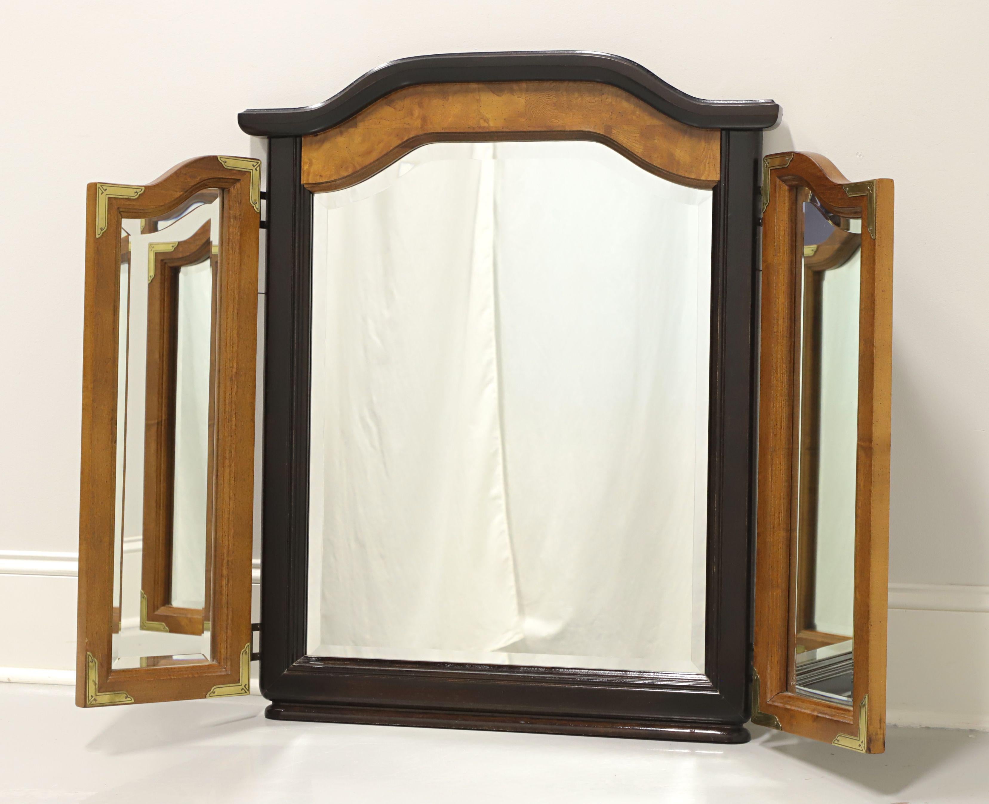 An Chinoiserie Ming style tri-fold dresser mirror by Broyhill Premier. Hardwood, burlwood and black lacquer with brass accents. Features bevel edge center mirror with a traditional Ming shape and two bevel edge side mirrors that can fold inward.