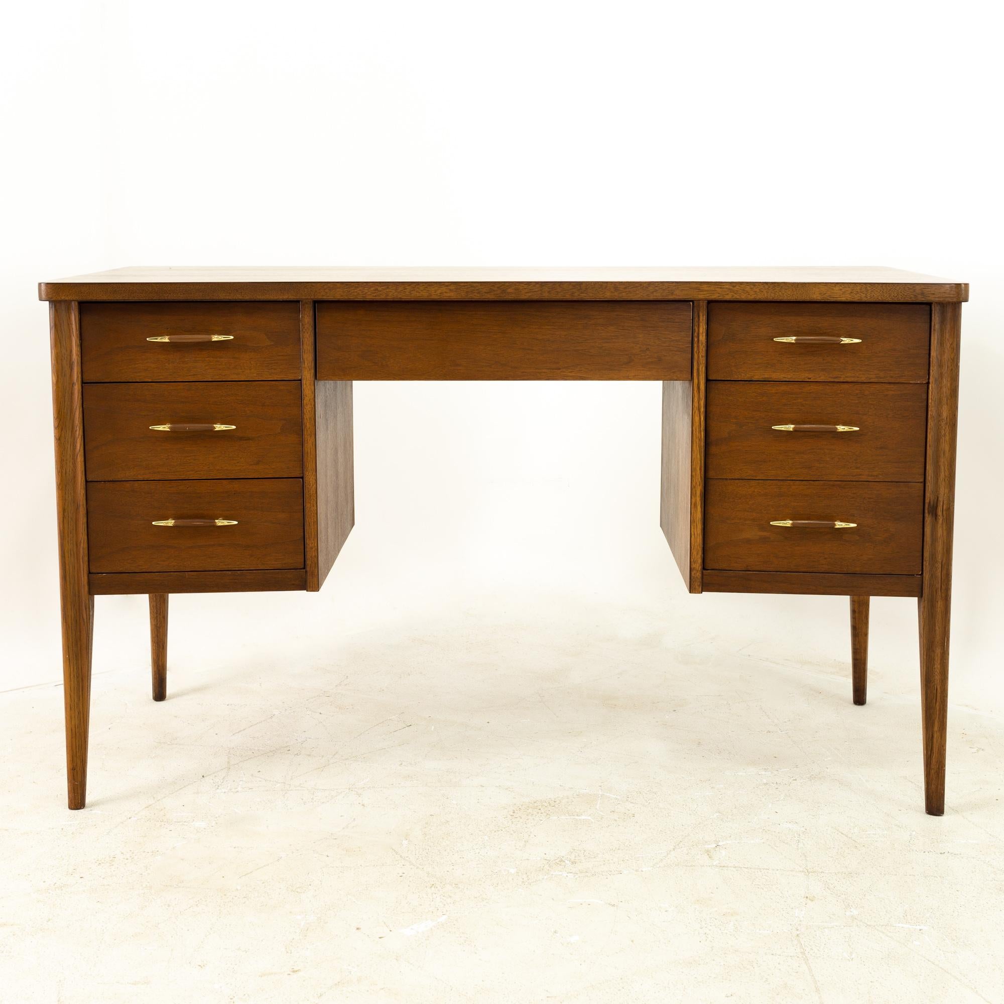 Broyhill Premier Saga mid century walnut and brass desk

This desk measures: 50.5 wide x 22.25 deep x 30.5 inches high, with a chair clearance of 24.5 inches

All pieces of furniture can be had in what we call restored vintage condition. That