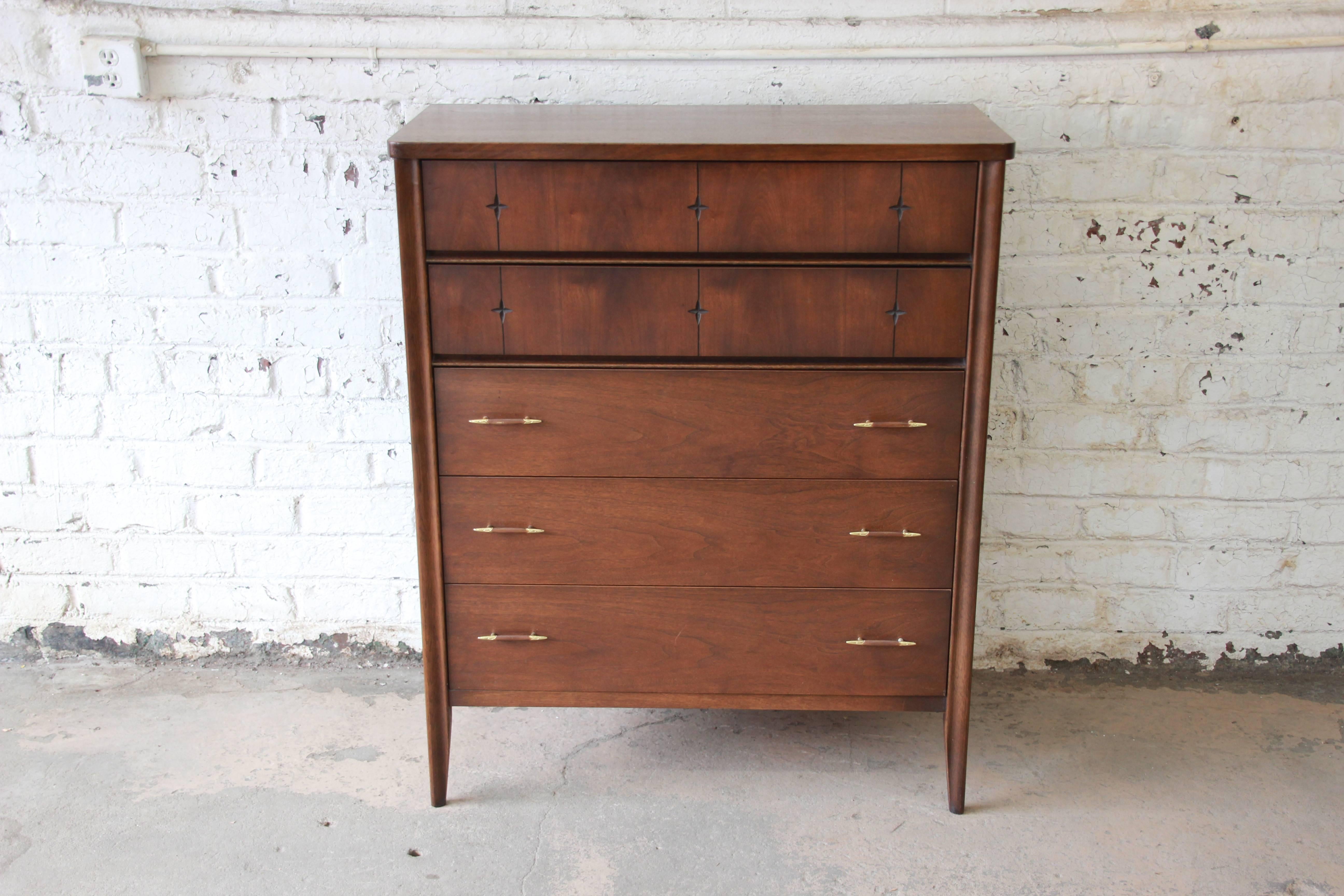 A very nice Mid-Century Modern sculpted walnut highboy dresser from the iconic 