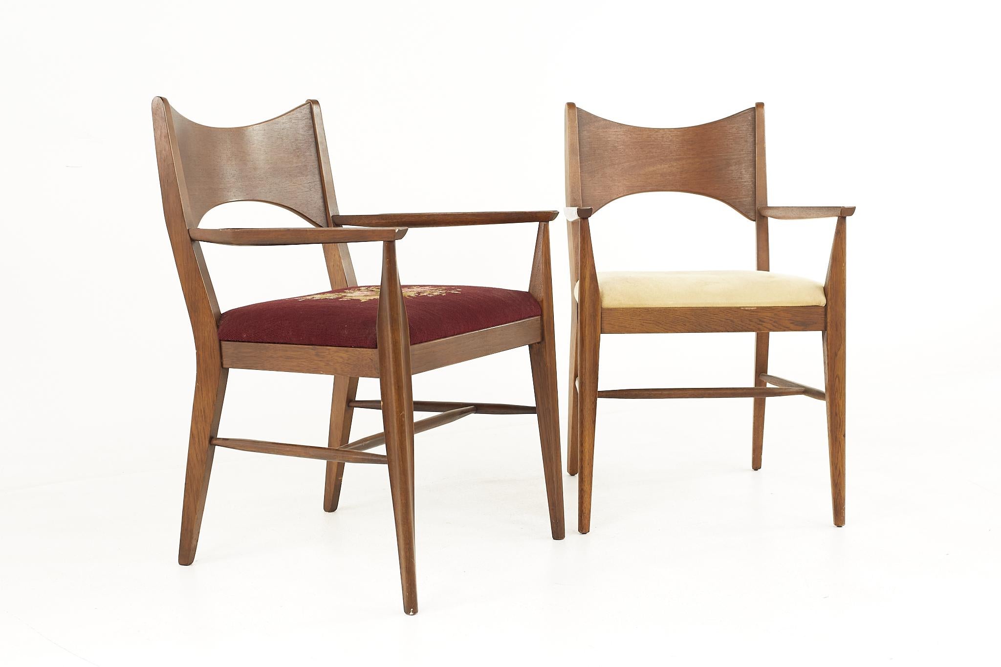 Broyhill Saga midcentury Walnut Captain Dining Chairs - Pair

Each chair measures: 22 wide x 23.5 deep x 34 high, with a seat height of 18.5, arm height of 25.5 and chair clearance of the chairs with arms is 25.75 inches

All pieces of furniture