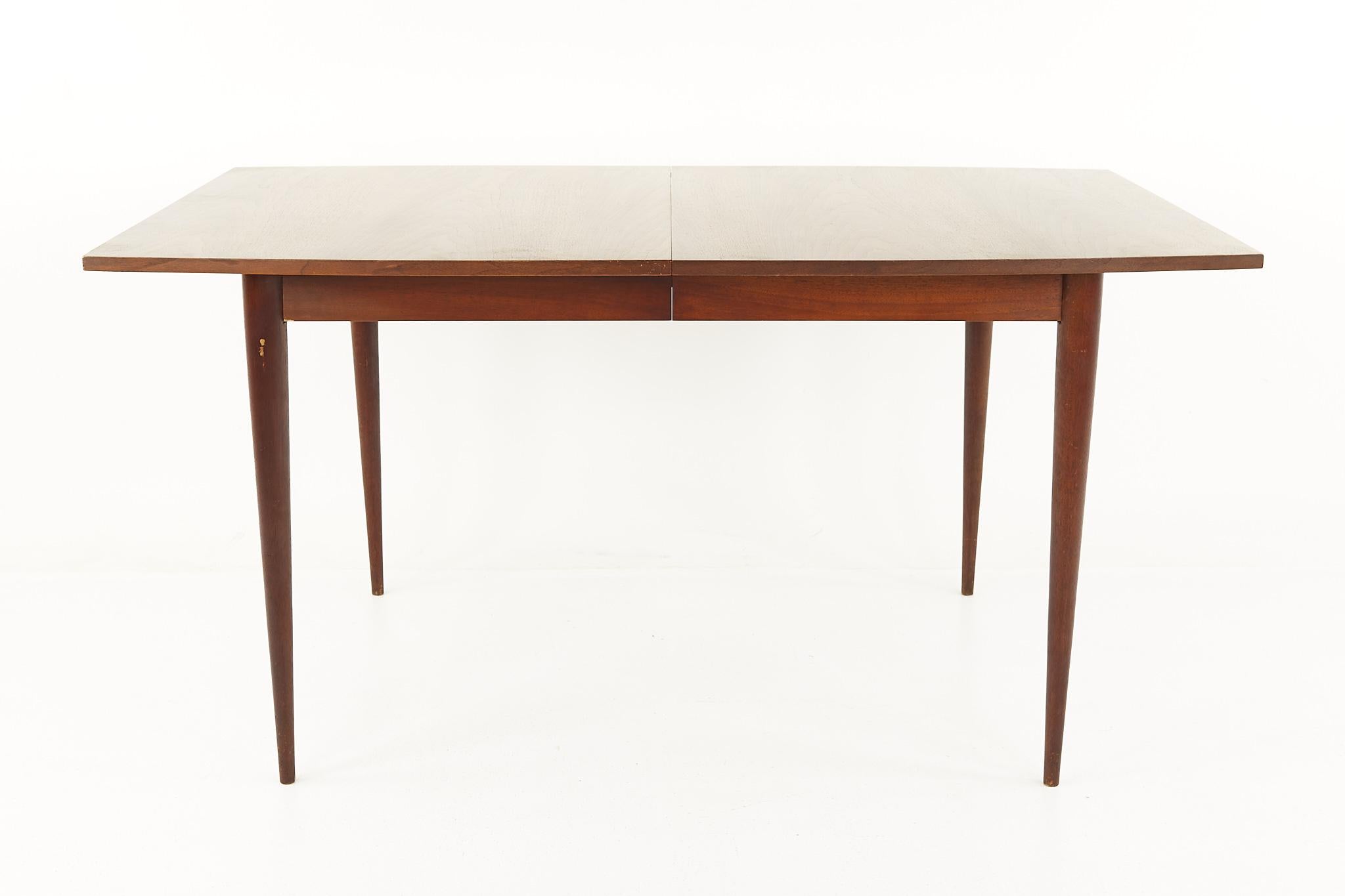 Broyhill Sculptra mid century walnut dining table with 3 leaves

This table measures: 60 wide x 40 deep x 29.75 inches high, with a chair clearance of 26.75 inches, each of the 3 leaves measure 12 inches wide, making a maximum table width of 96