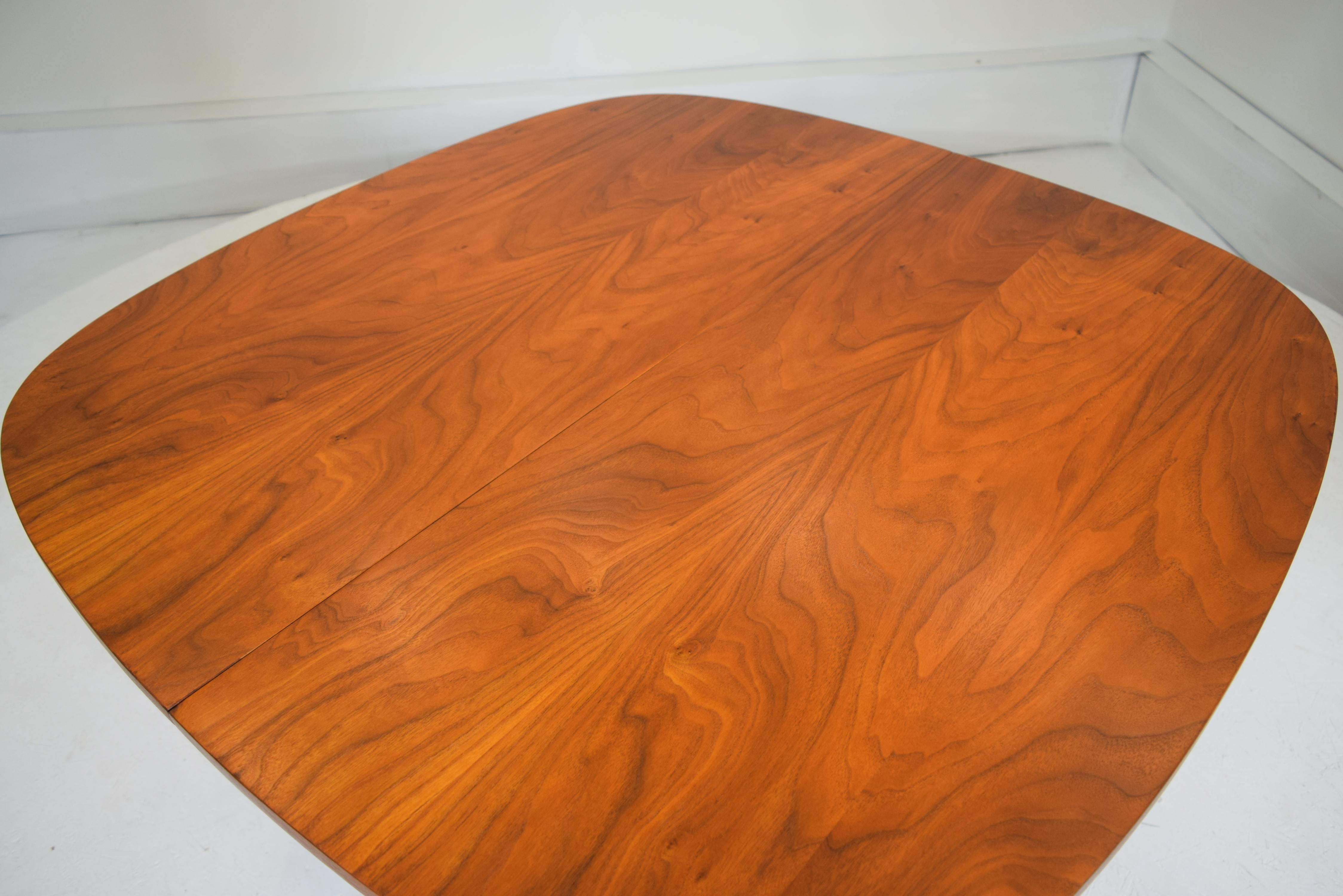 Broyhill, premier walnut dining table. Pristine like new condition. Heavy and sturdy, American black walnut used with dramatic effect. A perfect square table that extends with perfect cornering for elegance and practicality. Entirely refinished and