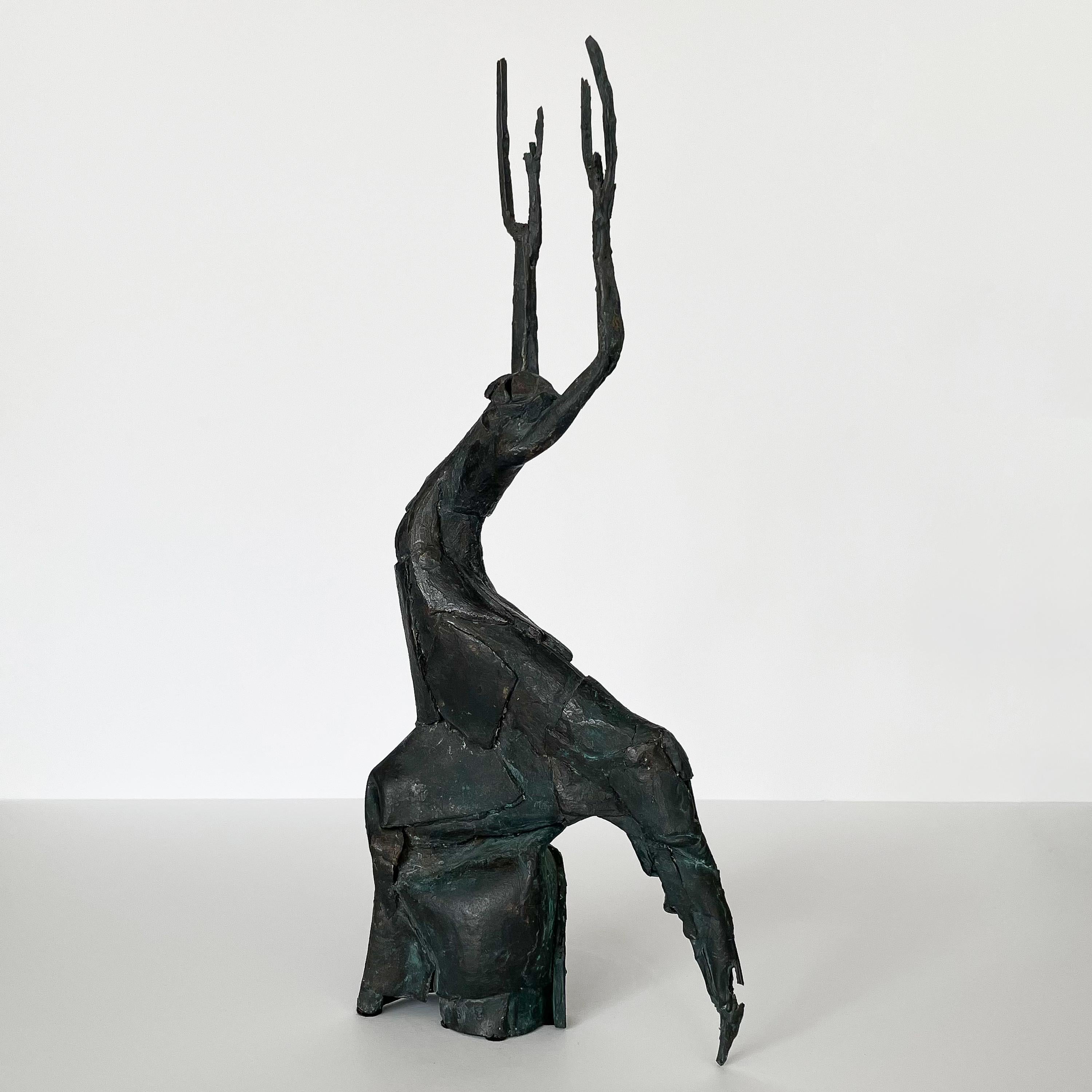 A unique mid century solid bronze figurative abstract sculpture, signed. This patinated bronze sculpture is anthropomorphic in design with an unusual mix of an animal, human and tree. The arms of the figure reach upwards and extend into branches or