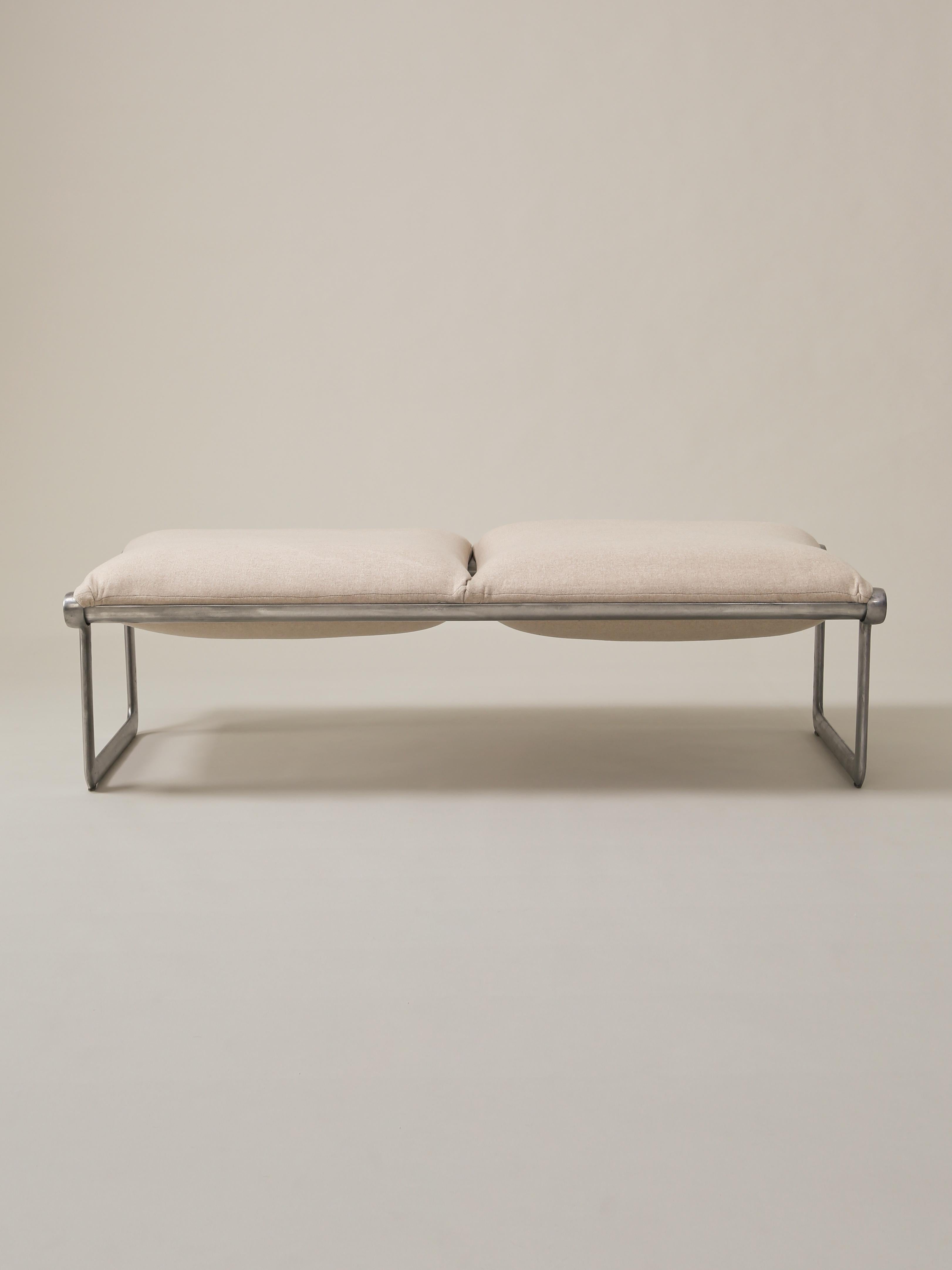 This Mid-Century Modern sling bench, designed by Bruce Hannah and Andrew Morrison for Knoll during the 1970s, features two seats, reupholstered in a bone cashmere. The steel base is original.

Measures: Overall width: 55”
Overall depth: