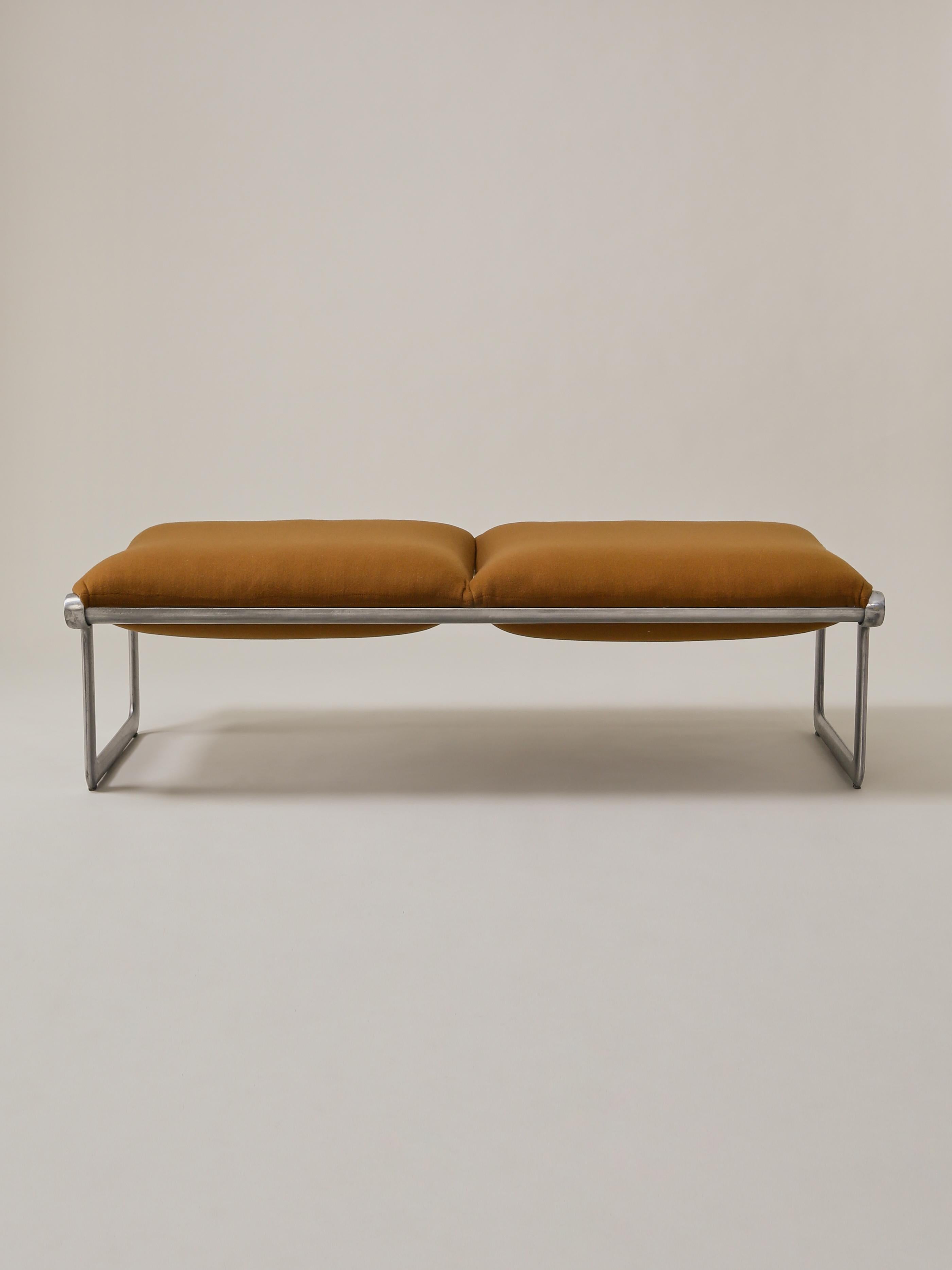 This Mid-Century Modern sling bench, designed by Bruce Hannah and Andrew Morrison for Knoll during the 1970s, features two seats, reupholstered in a bronze cashmere. The steel base is original.

Measures: Overall width: 55”
Overall depth: