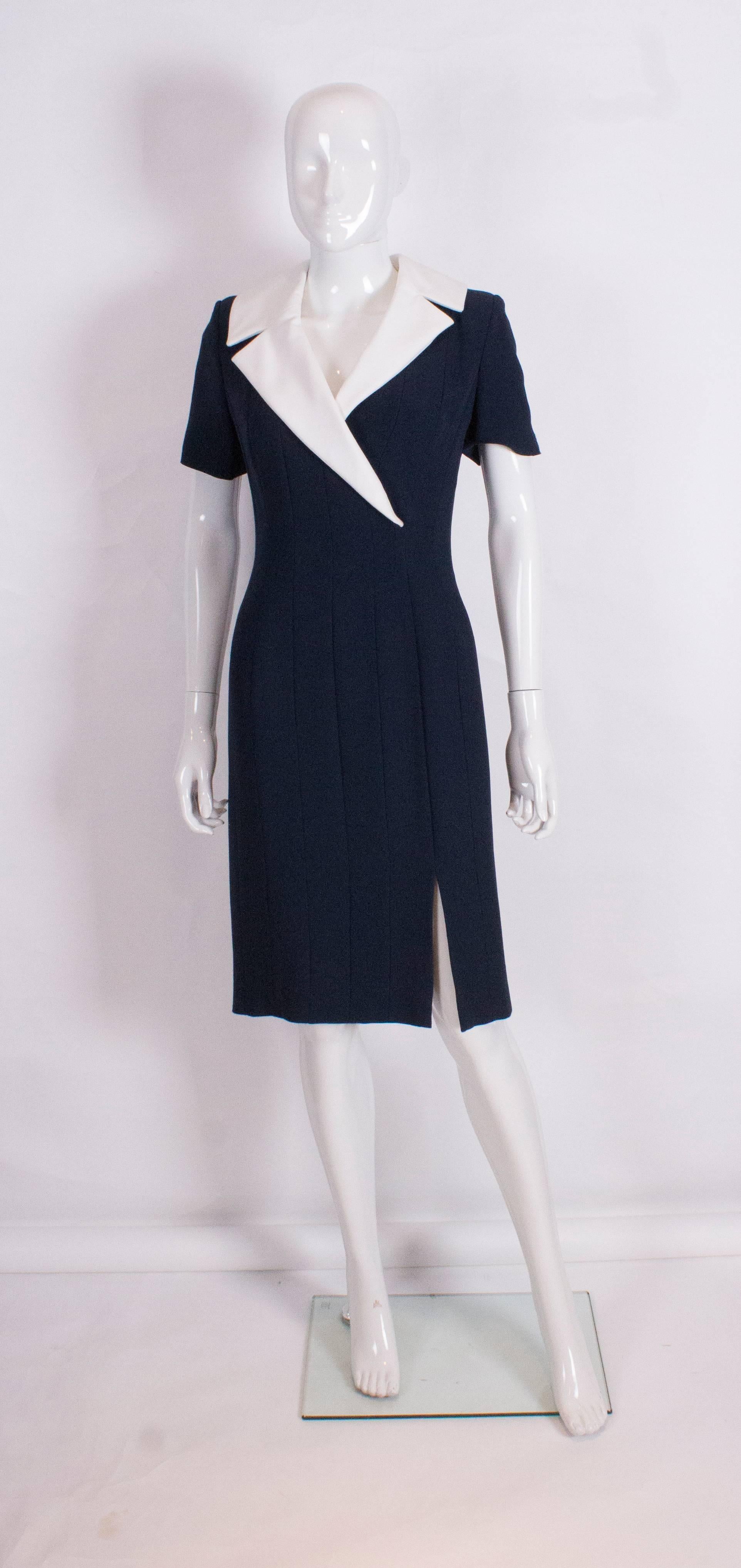 A chic blue dress by Bruce Oldfield Couture with detachable collar. The dress is lined in silk, and has a central back zip, short sleeves and an 8 1/2'' slit at the front left side.