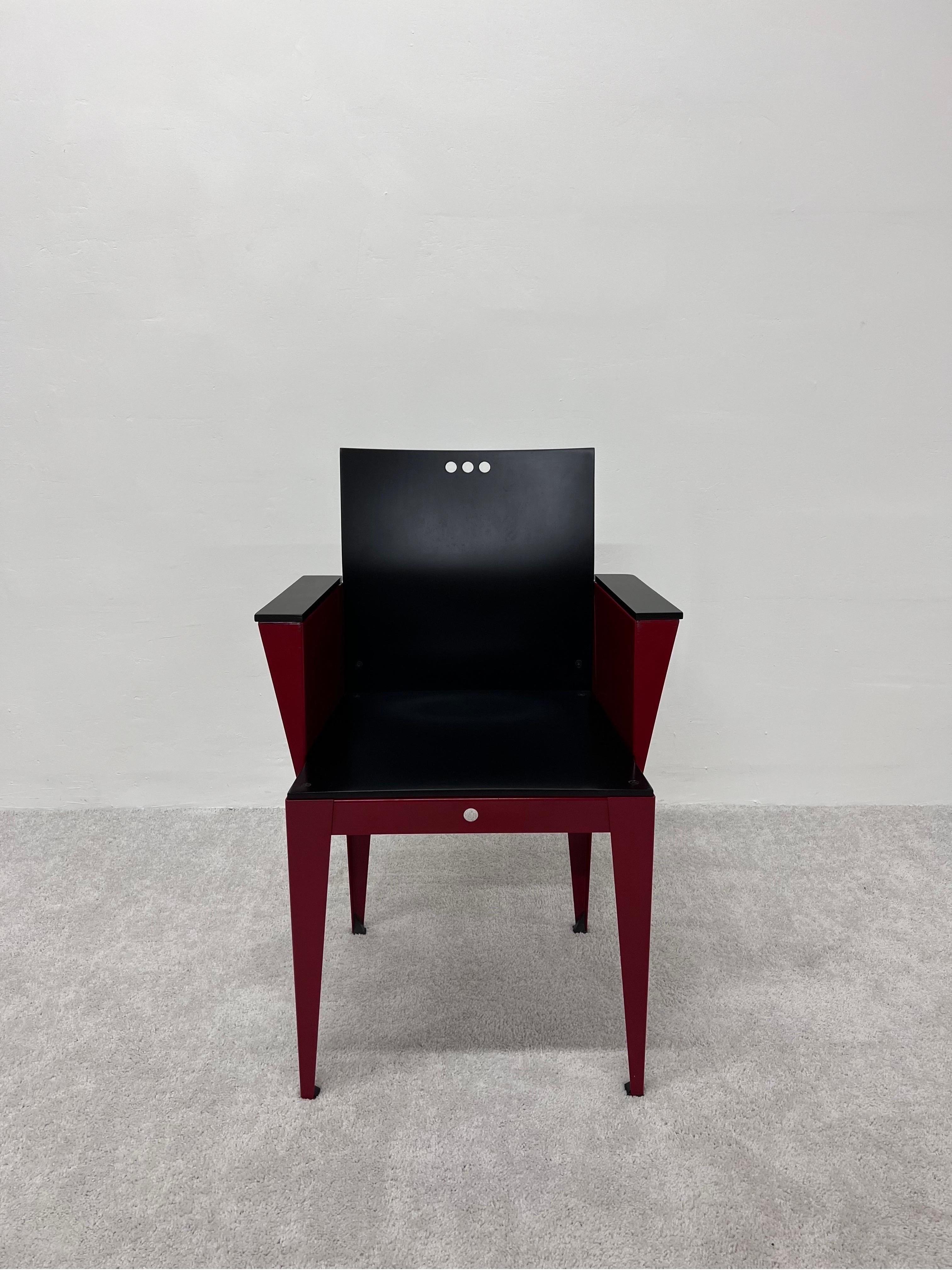 Rare Eli armchair with matte black maple wood seat, back and arms attached to a red lacquered steel base. Designed by Bruce Sienkowski for Charlotte, 1991. 

The wood has been refinished to its original state. Red lacquered frame is