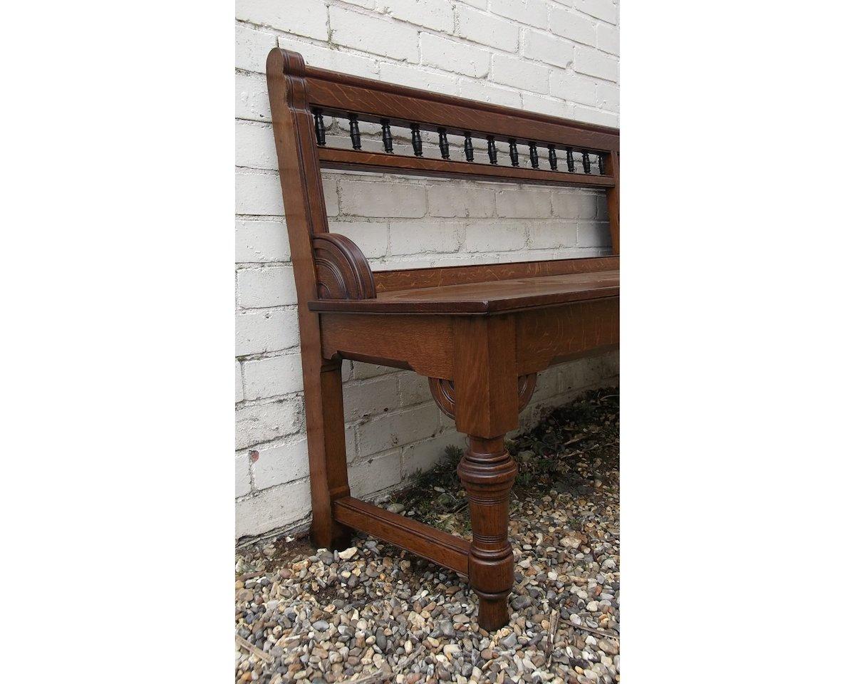 English Bruce Talbert, attr, a Long Aesthetic Movement Oak Bench with Carved Florets