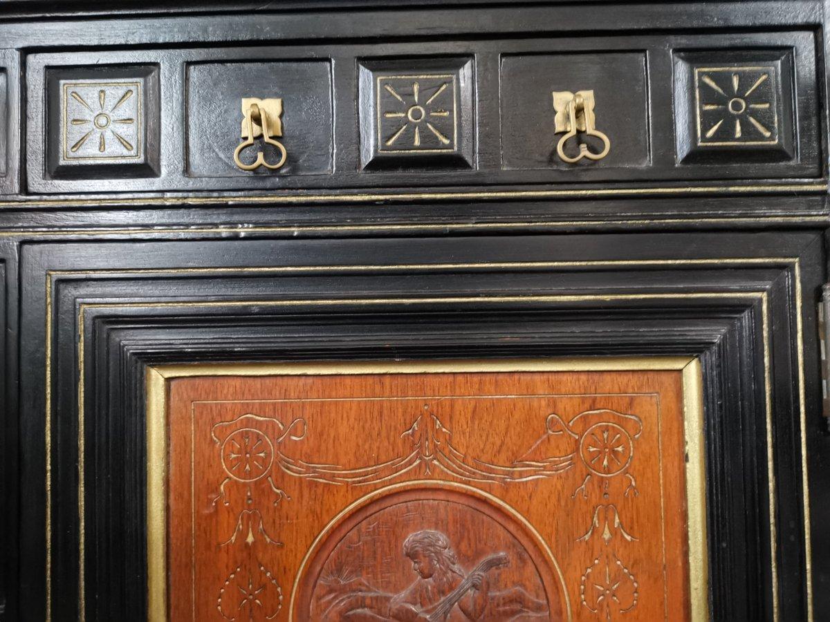 Walnut Aesthetic Movement Side Cabinet with Carved panels of Putti Putti playing music. For Sale