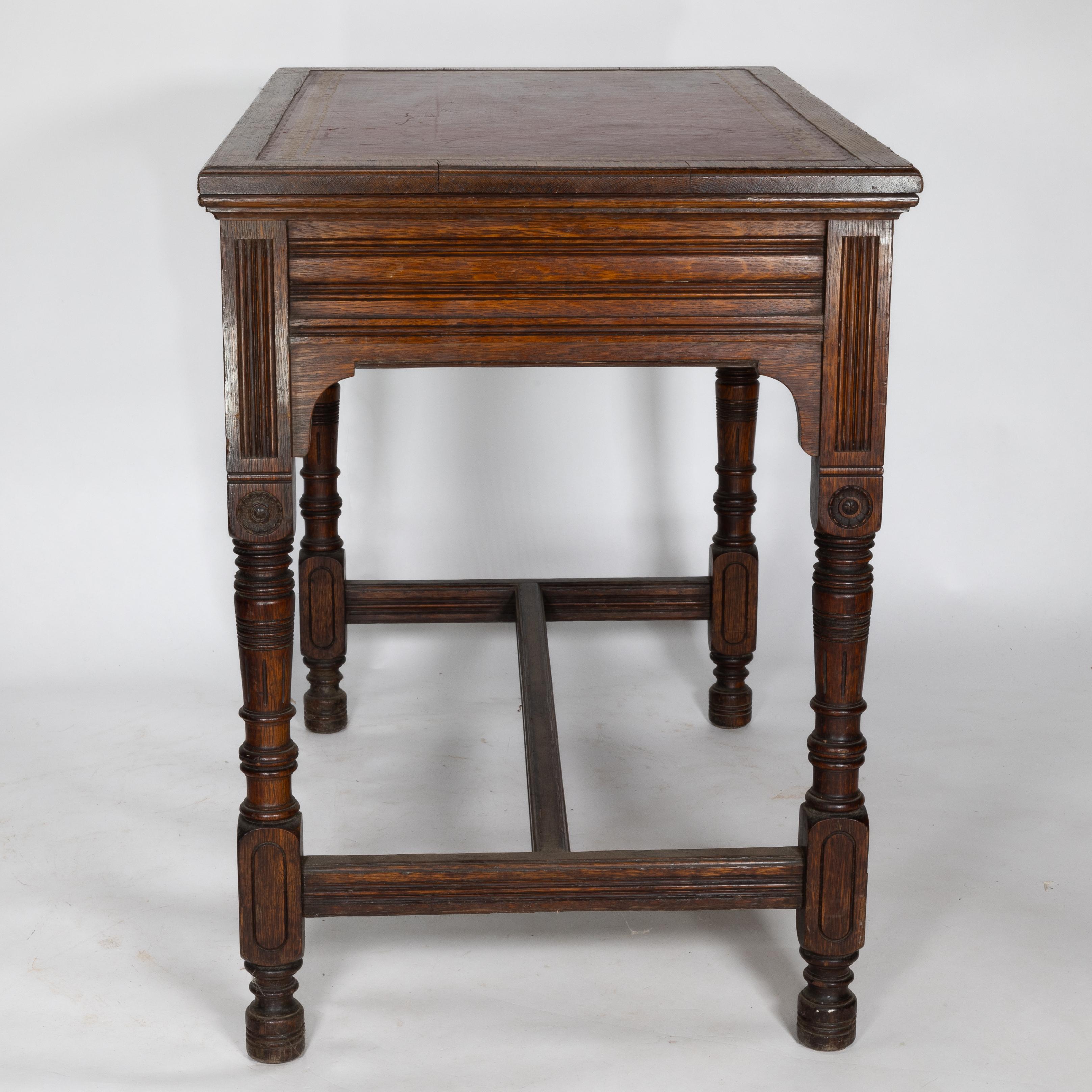 Bruce Talbert for Gillow and Co. A Gothic Revival Oak and Leather Writing Table In Good Condition For Sale In London, GB