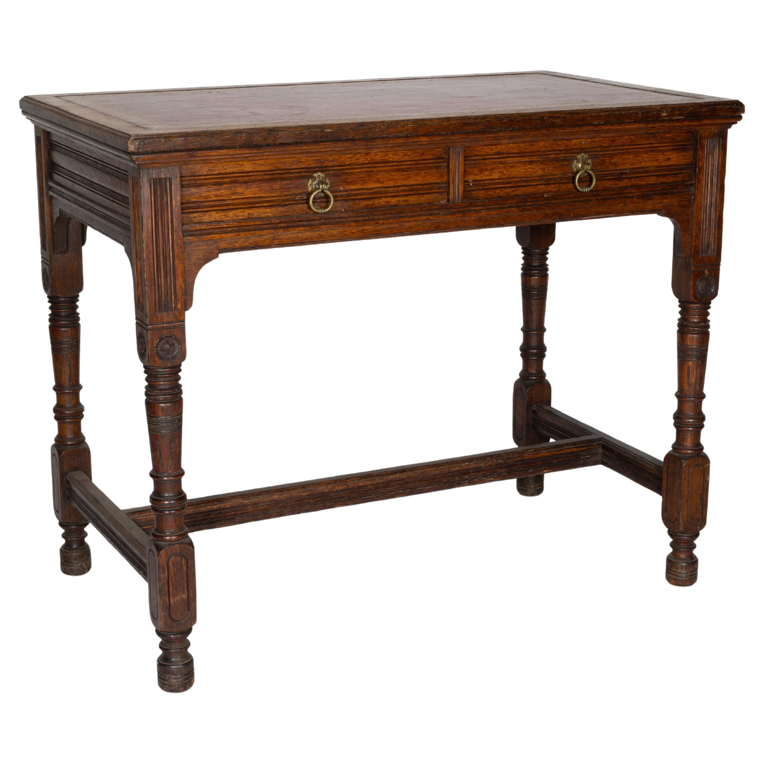 Bruce Talbert for Gillow and Co. A Gothic Revival Oak and Leather Writing Table