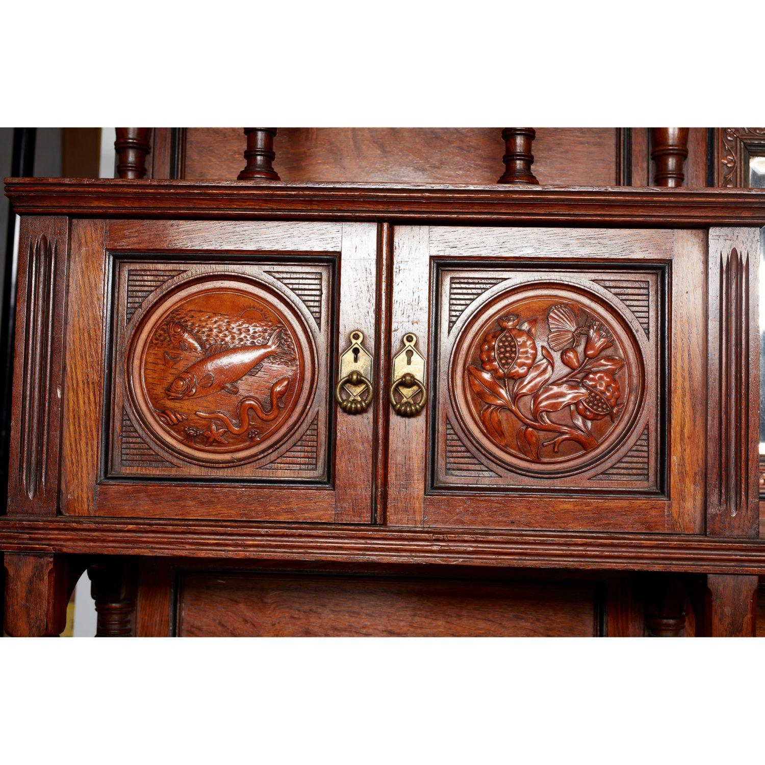 Bruce Talbert. for Gillows of Lancaster.
An outstanding Aesthetic Movement exhibition quality Walnut sideboard with double horizontal dentil cornice, the central original bevelled mirror surrounded by three leaf clovers, flanked by upper display