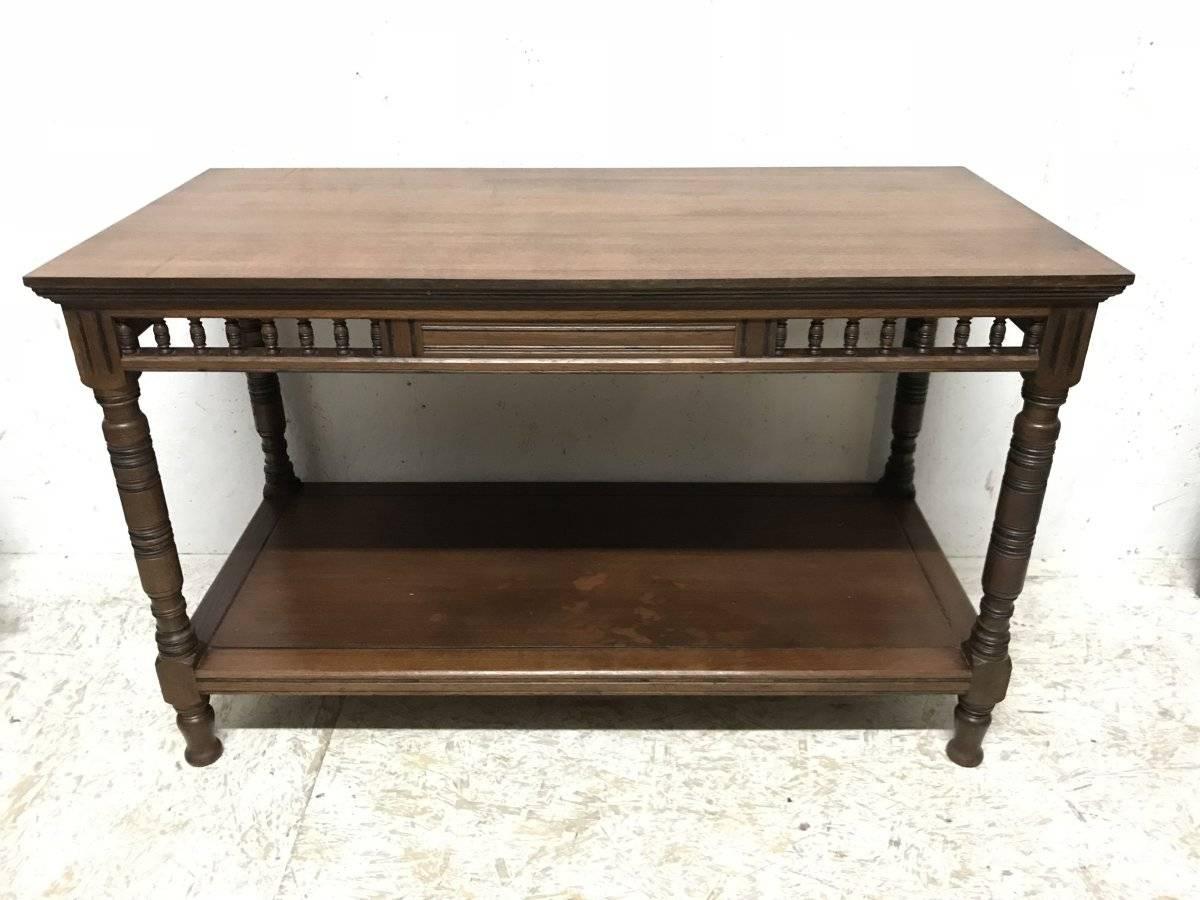 Bruce Talbert, Attributed, a Gothic Revival walnut library or serving table with turned gallery below the upper serving area, on turned legs with ebonized details united by a full size lower shelf all sat on Thebes style feet, probably made by