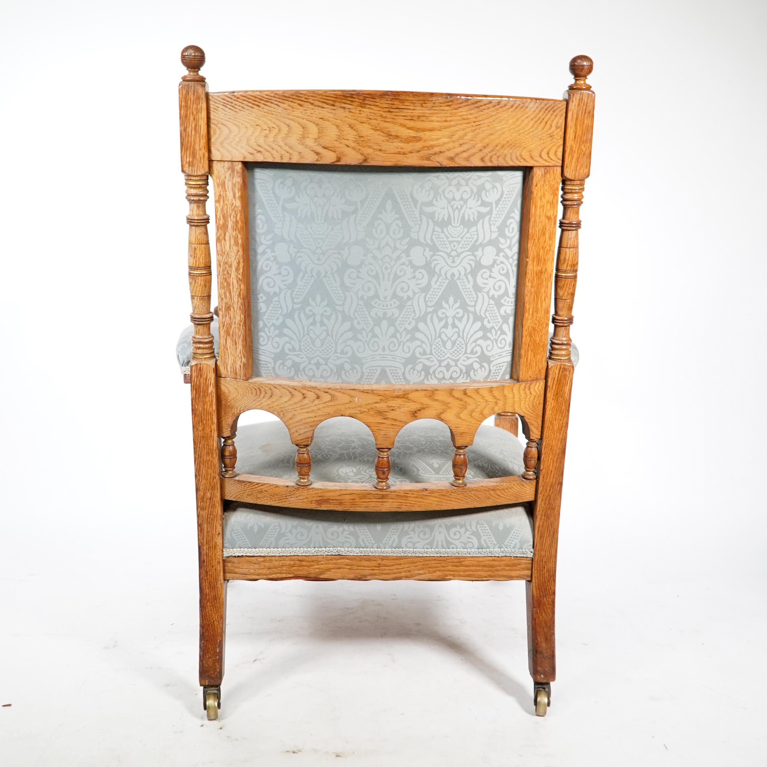 Bruce Talbert, stamped Gillows. An Aesthetic Movement upholstered oak armchair. For Sale 1