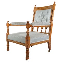 Antique Bruce Talbert, stamped Gillows. An Aesthetic Movement upholstered oak armchair.