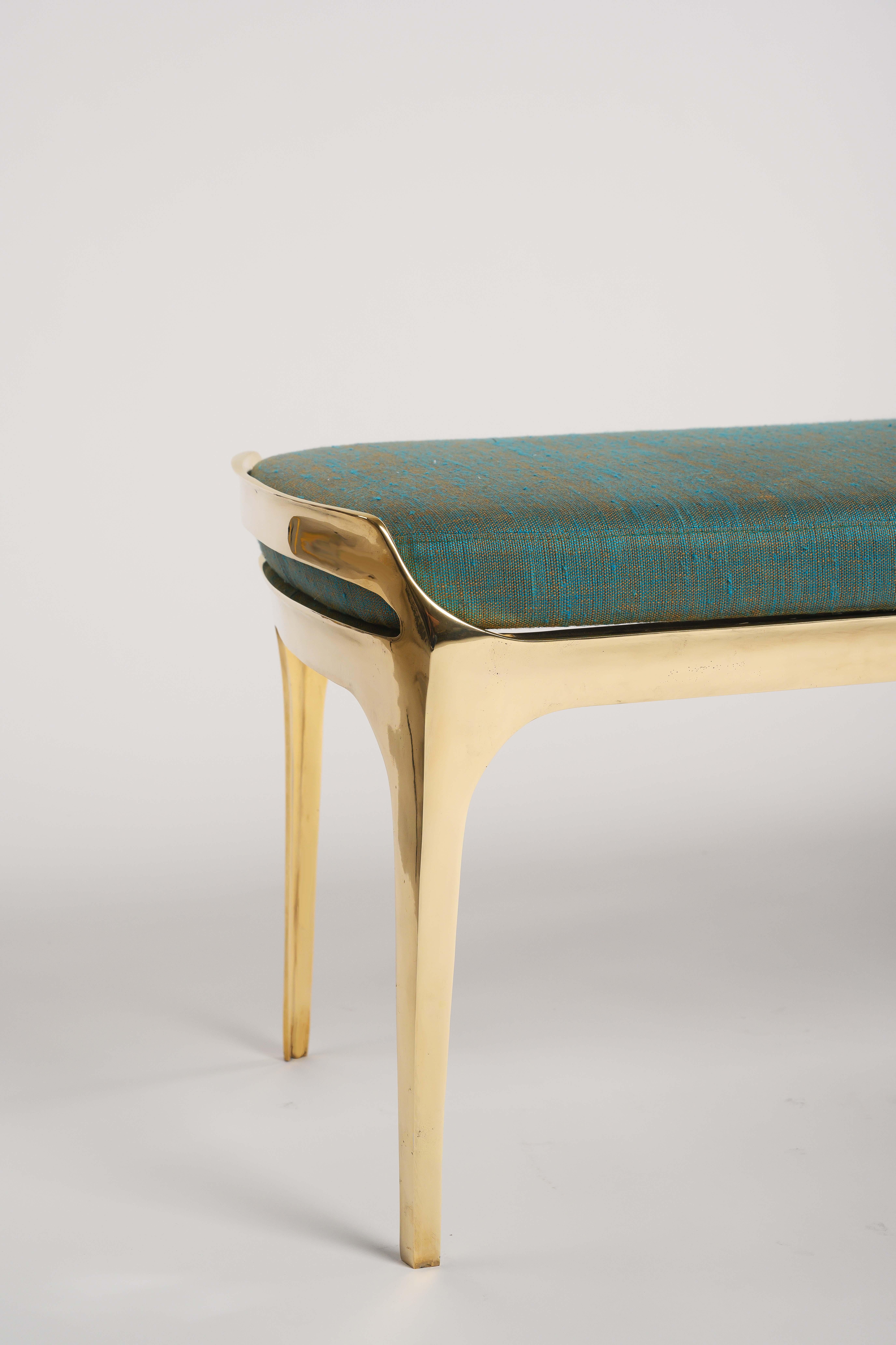 Available now at the Elan Atelier NY Showroom.

Cast bronze Bruda bench in polished gold frame finish with marine blue silk-linen seat cushion. 

Gold and silk, two great prizes of antiquity, are combined in the Bruda Bench into a faintly nautical