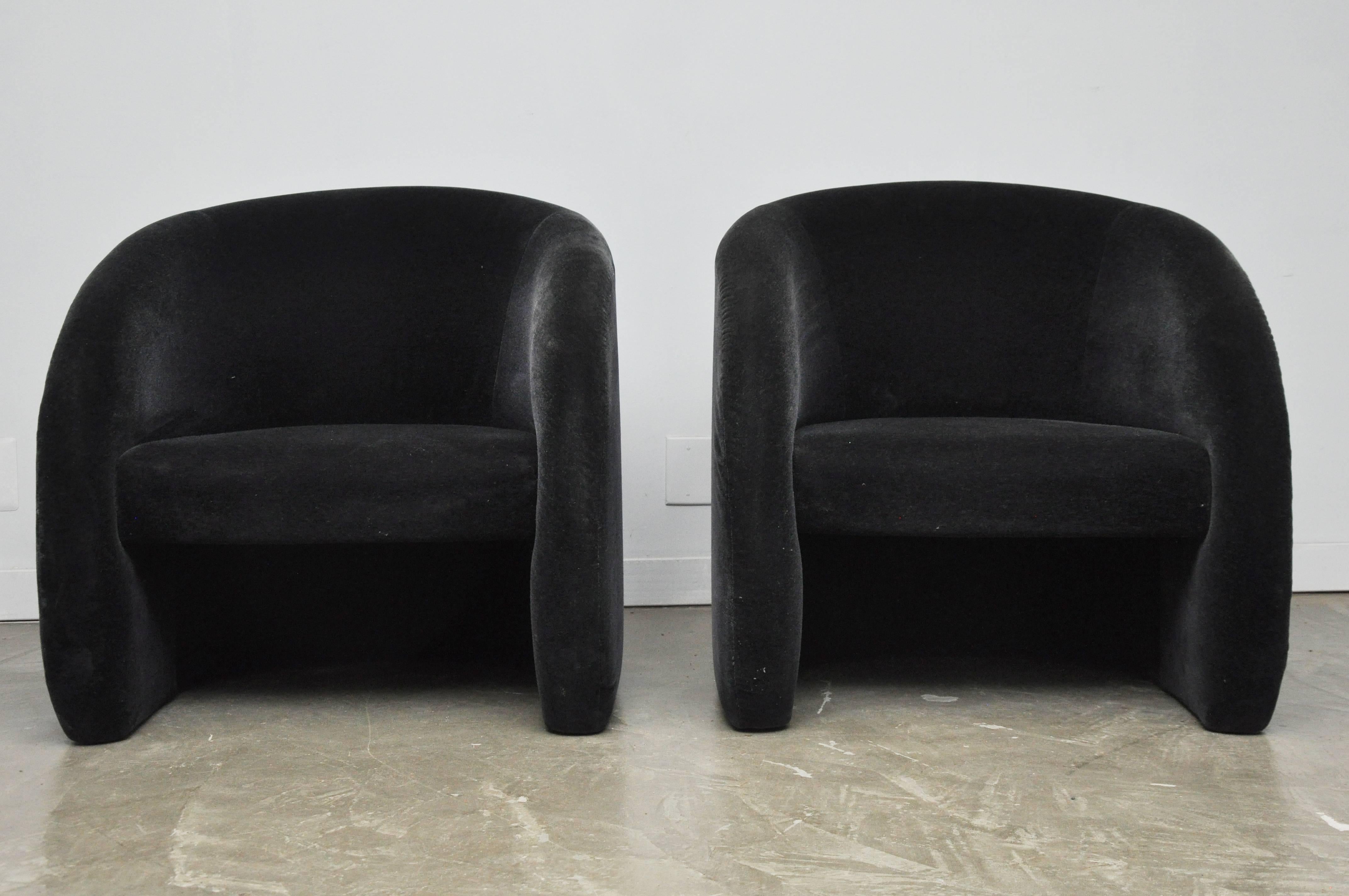 Pair of curvaceous barrel back lounge chairs by Brueton. Original black Mohair is in excellent condition.