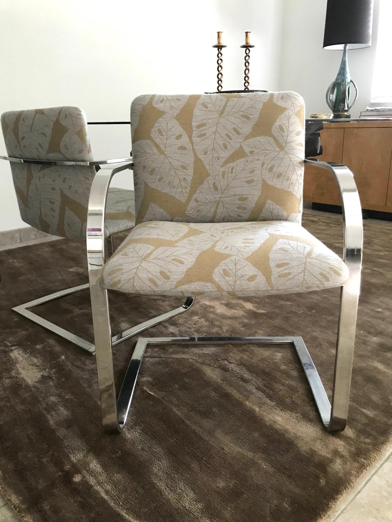 Mid-Century Modern desk chair or side chair with cantilevered steel frame in chrome. Chair has streamlined profile with curved armrests and floating seat design. Newly upholstered in handwoven fabric with bold tropical leaf print in hues of taupe