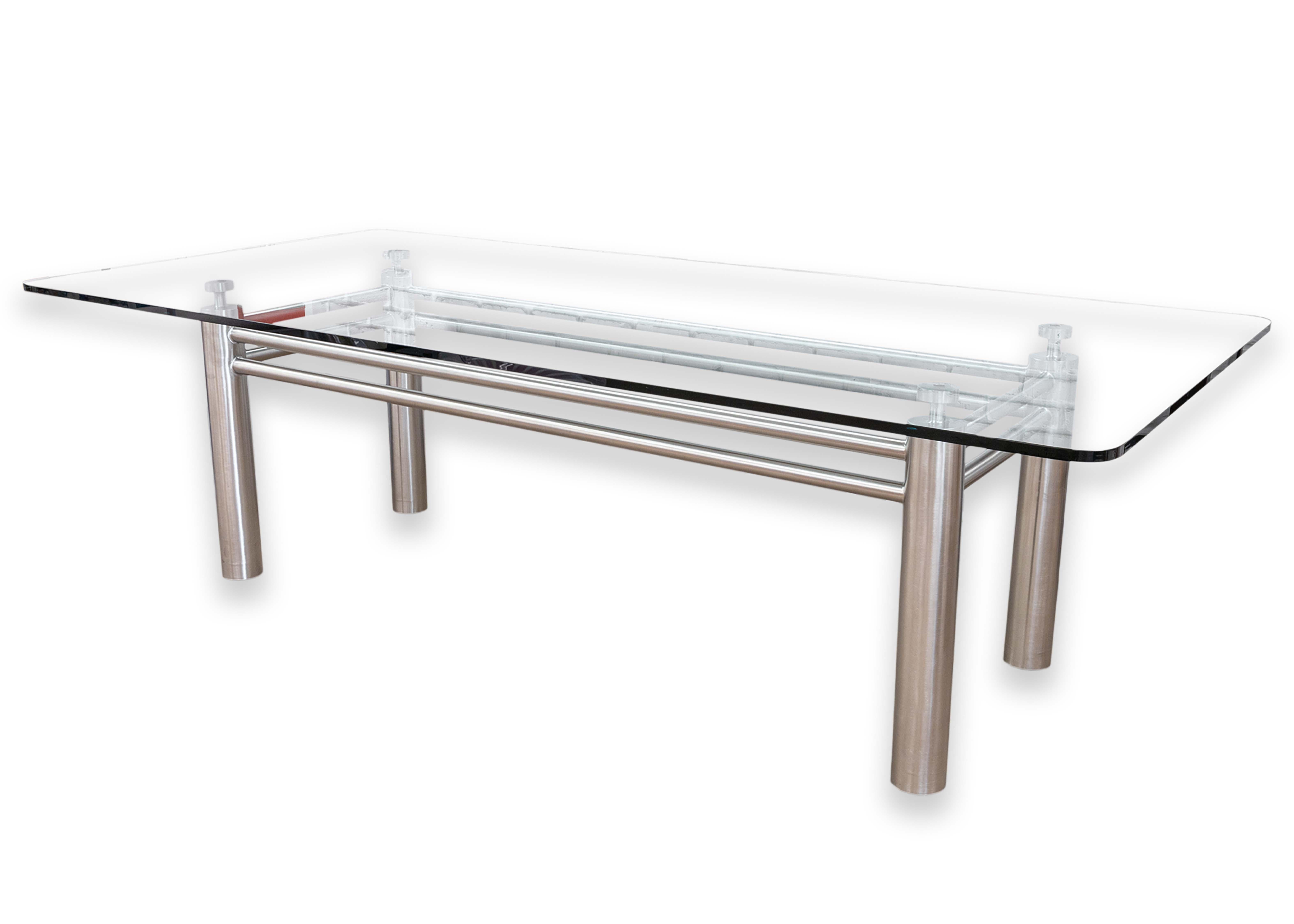 A contemporary modern glass and chrome steel dining table. This wonderful dining table features a large, thick rounded glass tabletop. The tabletop sits on a beautiful modern chrome steel base with a tubular design. Each of the four large