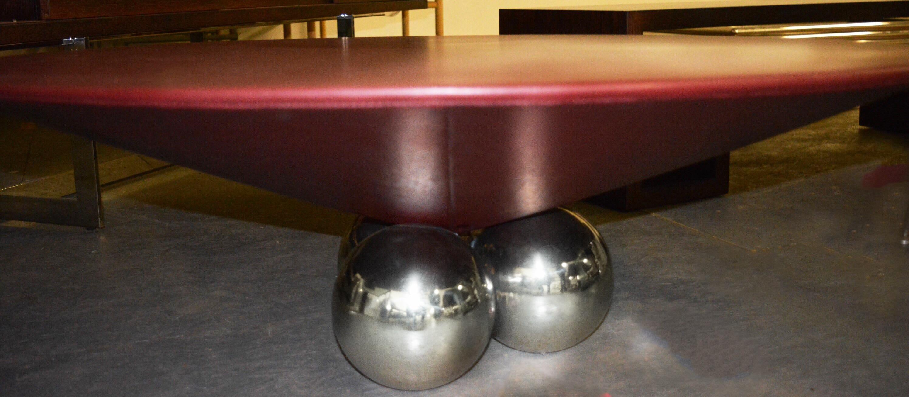 Gorgeous modern Conical Cordovan leather Bocci coffee table floating on a stainless steel orbular base - three seven-inch stainless steel orbs. Rare (custom) coffee table size. Brueton Industries, New York, circa 1980.