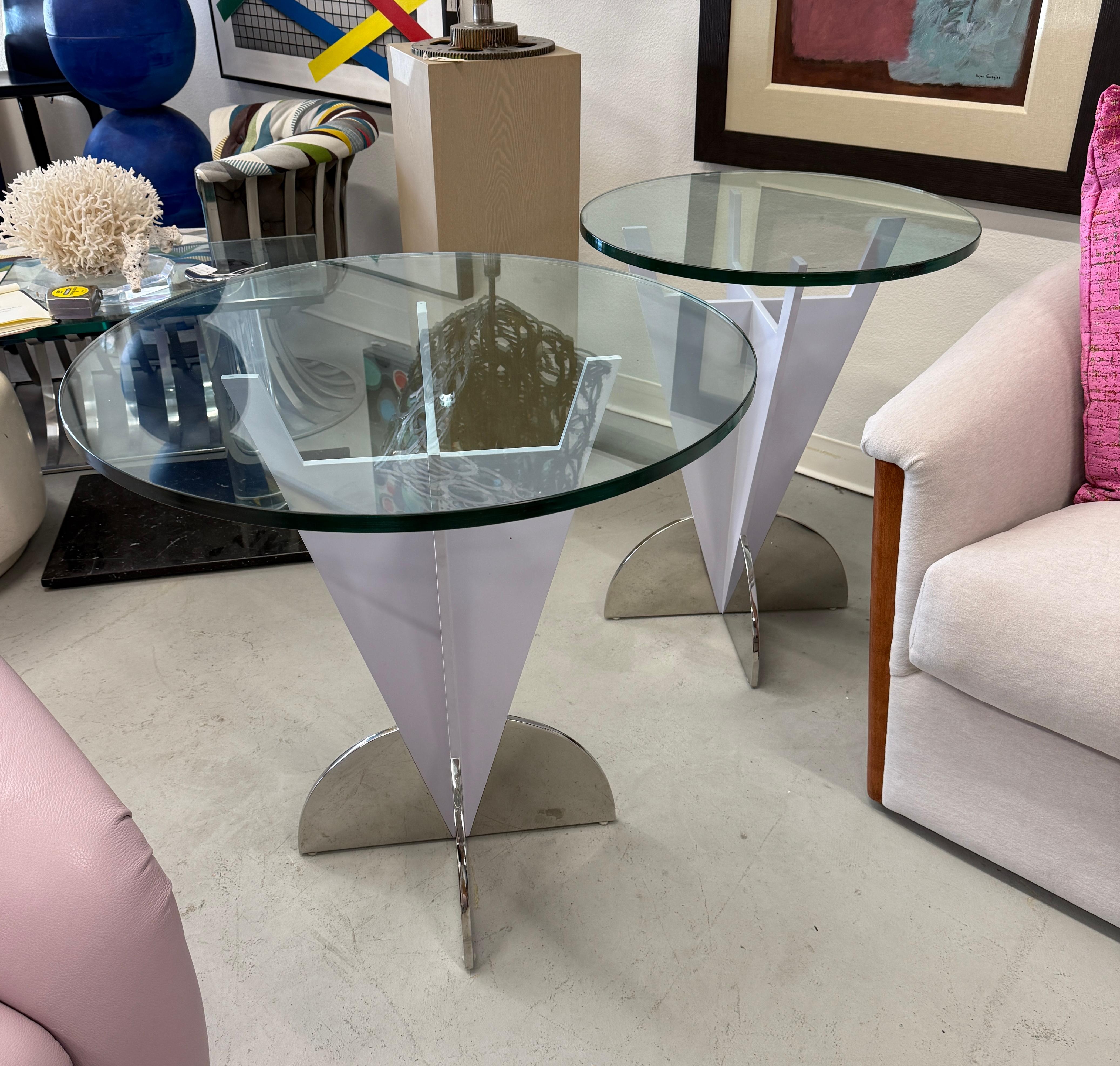 A beautiful pair of Breton Steel and enamel side or end tables. These were custom painted to match the decor in two different rooms so while similar are slightly different shades. They also have two different sizes of thick glass on the top. One is
