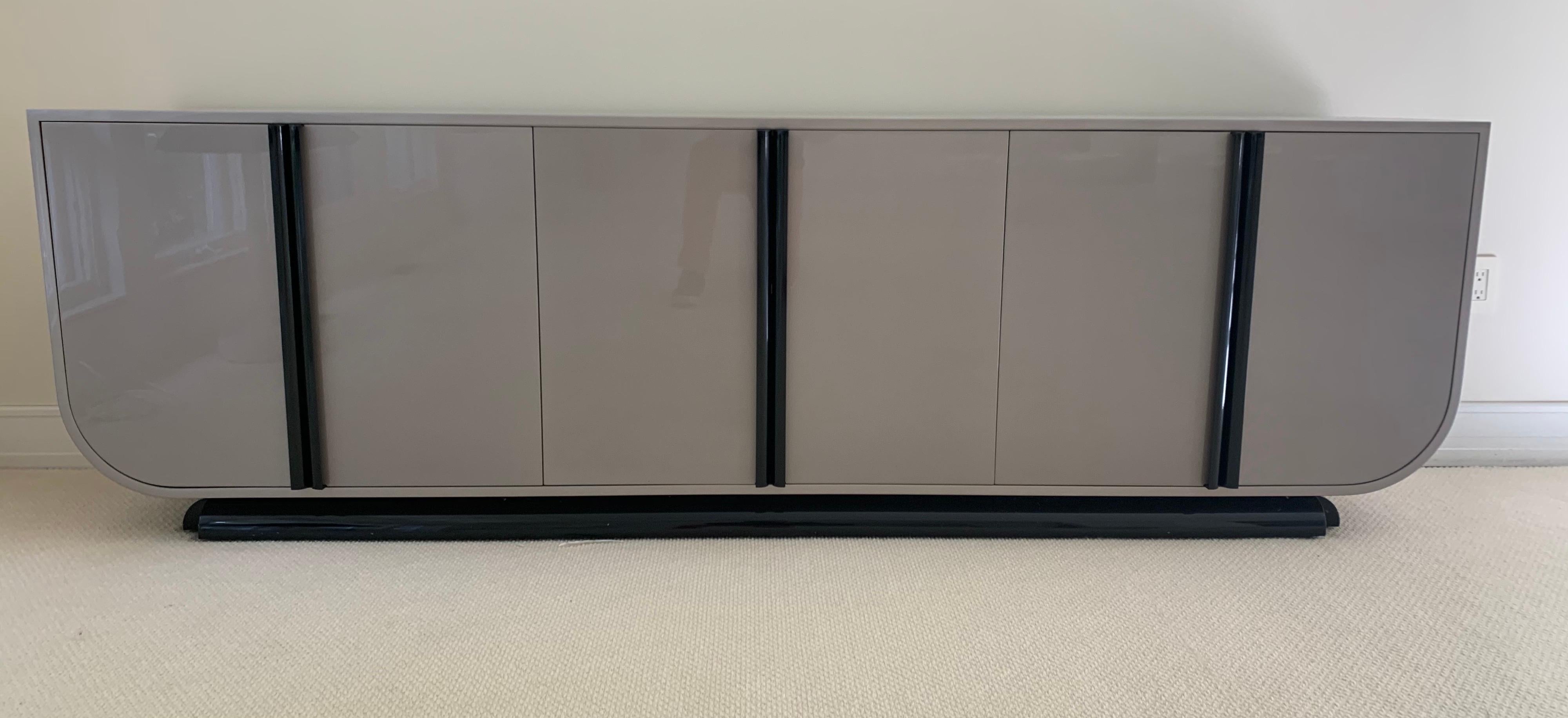 An iconic statement piece from Brueton. Dramatic gray lacquer with black handles make this piece stand out in a crowd. Please reference the dimensions below, this is a large piece and it is in great condition. There is ample storage inside the doors