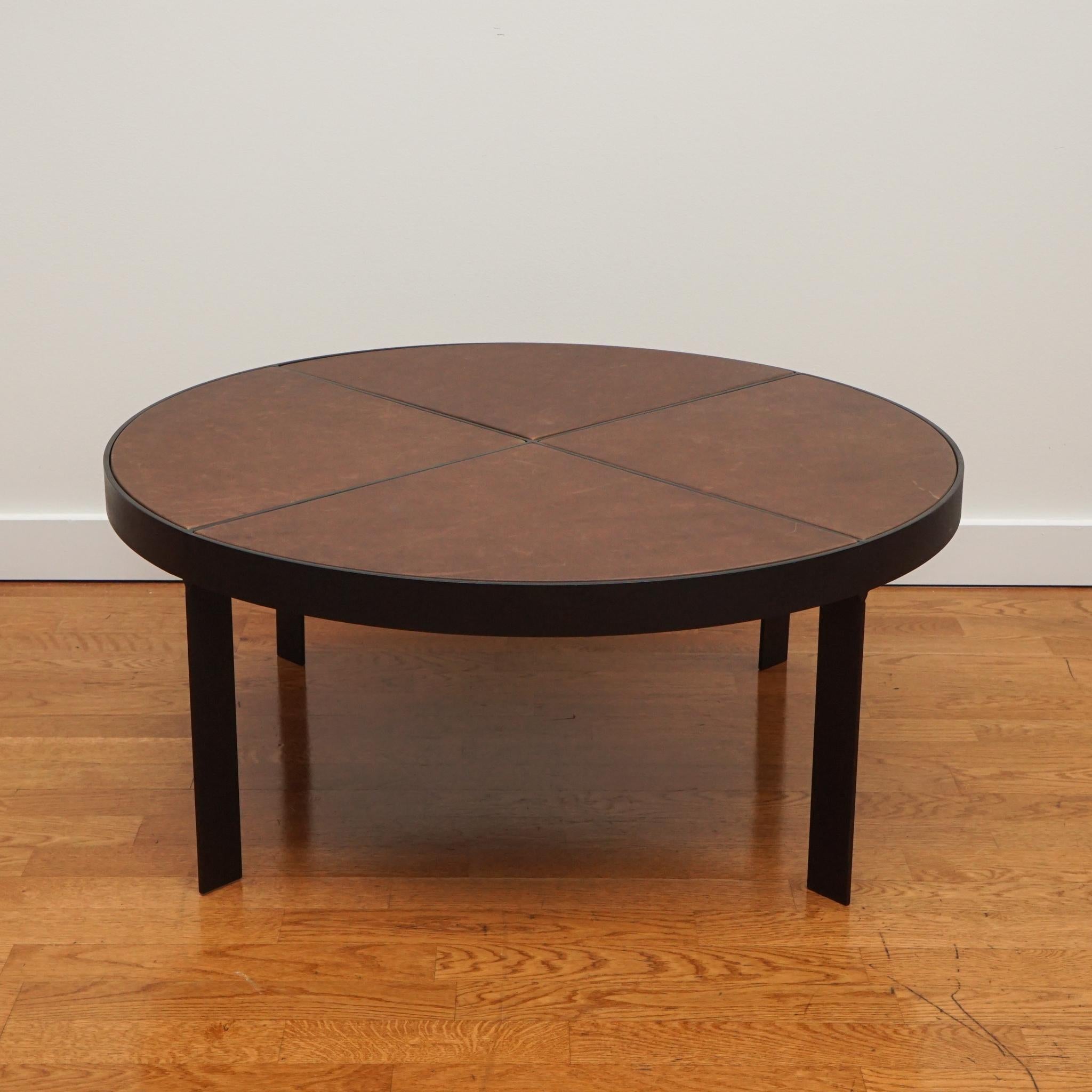 The Bruges coffee table is distinctive for its iron frame base and leather covered top surface. Generous in size and solidly made. It is displayed here in Berkshire Bourbon leather.  Beautiul sleek lines and sophisticated look, allows it to be an