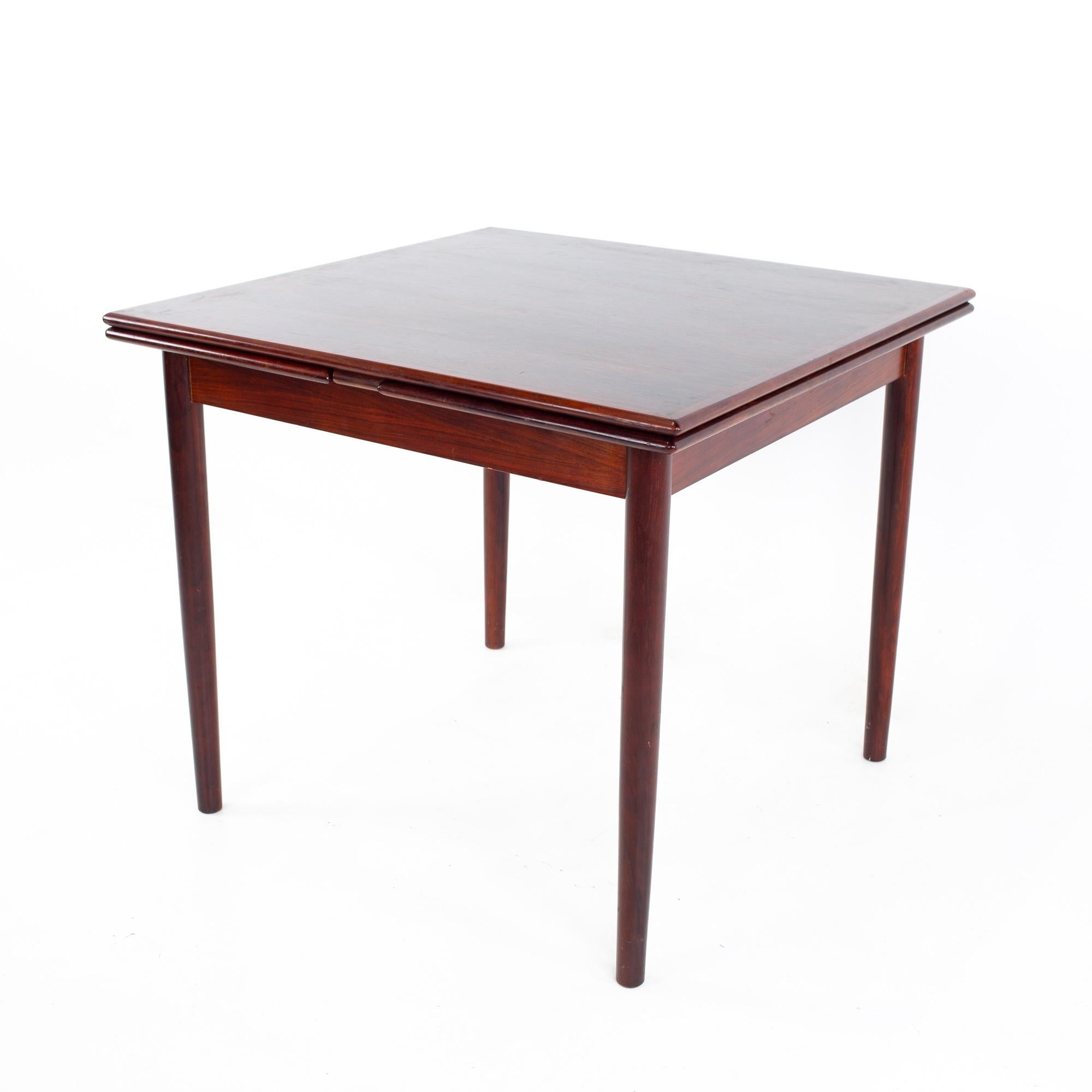 Bruksbo mid century rosewood hidden leaf game dining table
Table measures: 33.5 wide x 33.5 deep x 28.75 inches high; each leaf is 15.25 inches wide, making a maximum table width of 64 inches when both leaves are used

All pieces of furniture can