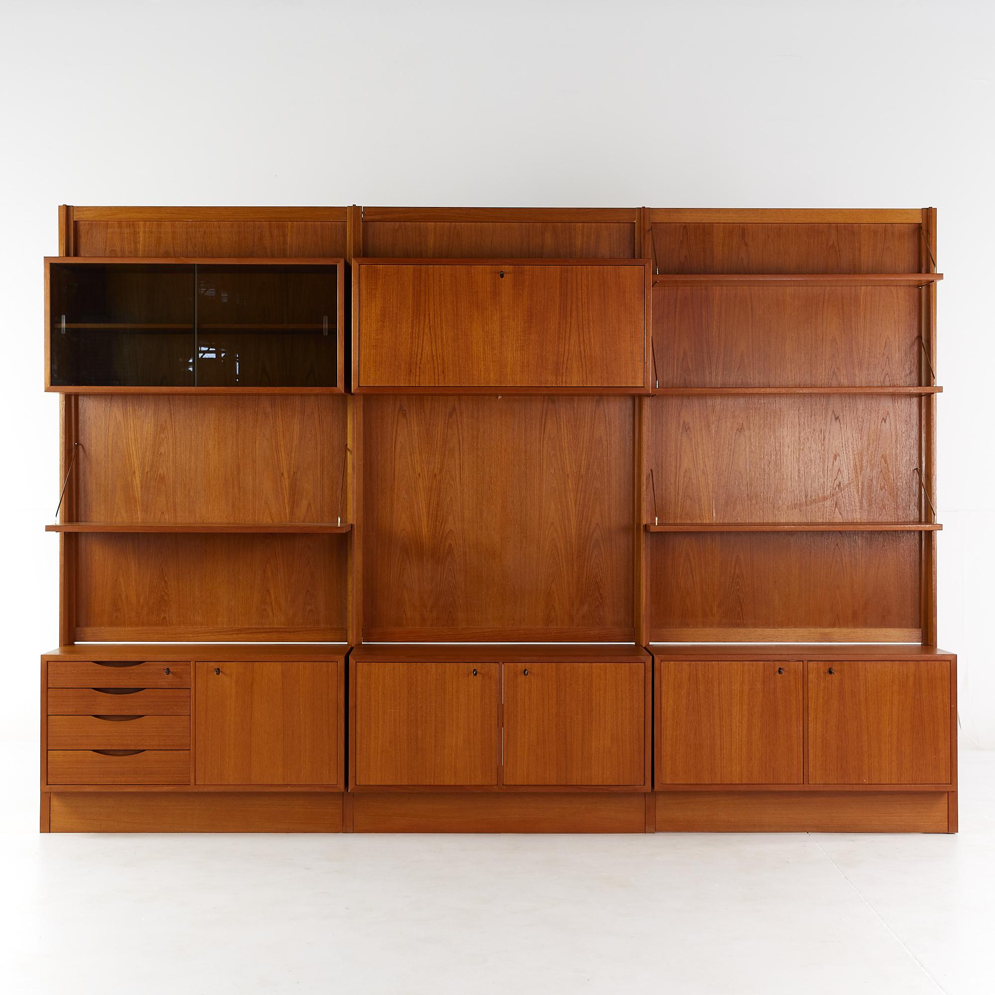 Bruksbo Mid Century teak freestanding wall unit

This wall unit measures: 106 wide x 15 deep x 74.5 inches high

All pieces of furniture can be had in what we call restored vintage condition. That means the piece is restored upon purchase so
