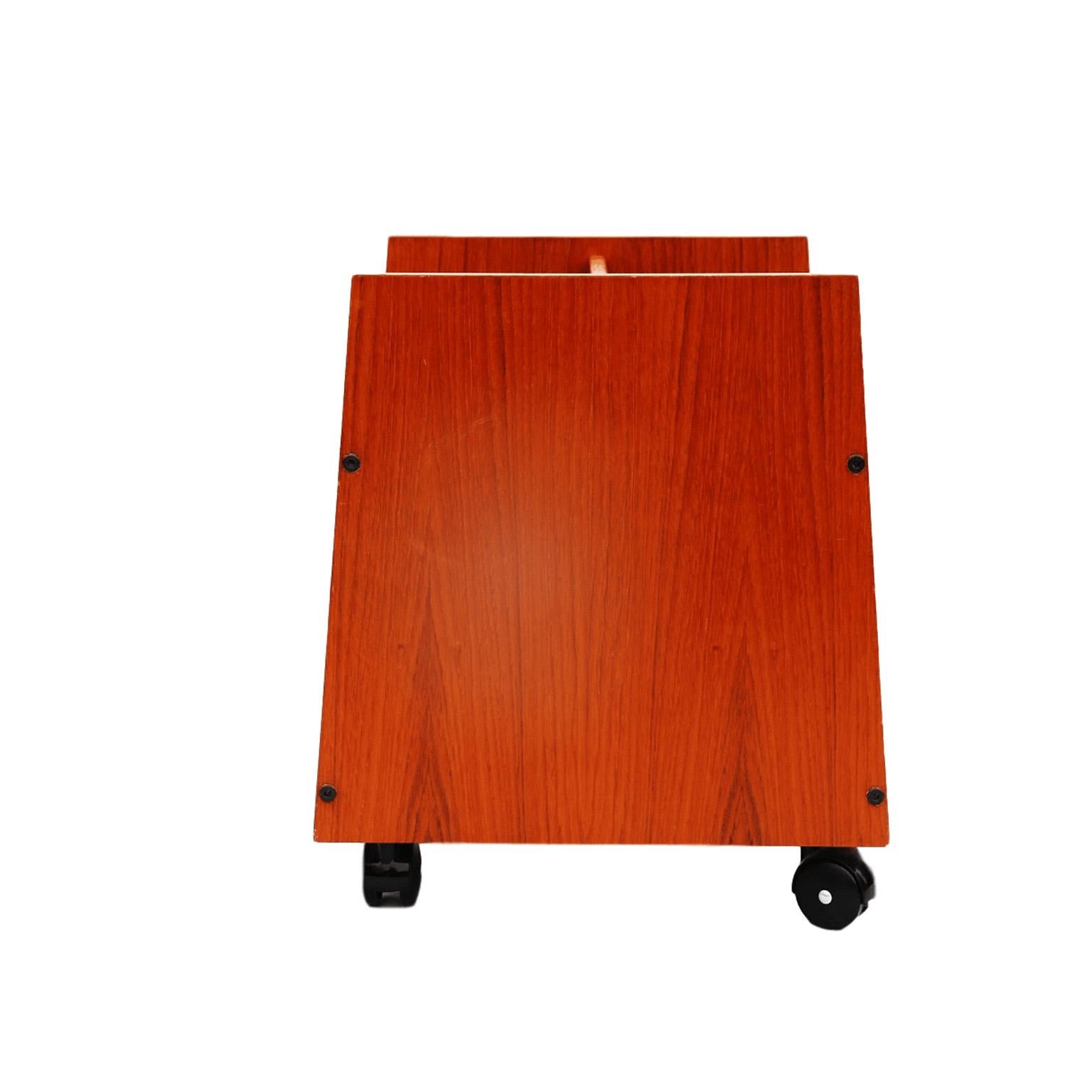 This beautiful vintage teak magazine holder is the perfect addition to your midcentury decor. Holds a ton of books and magazines and is built on beautiful vintage casters that roll smoothly and are very sturdy. Large enough to fit your record