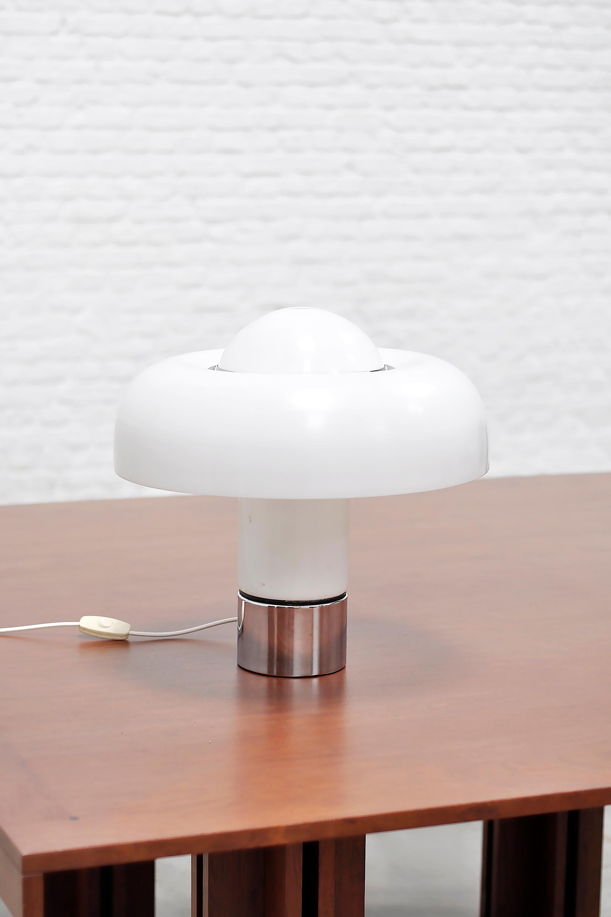 Disegnata da Luigi Massoni all'inizio degli anni '70 per Harvey Guzzini, la lampada Brumbury è un chiaro esempio di design italiano dell'illuminazione di quel periodo: formalmente audace, efficiente dal punto di vista dei materiali e accuratamente