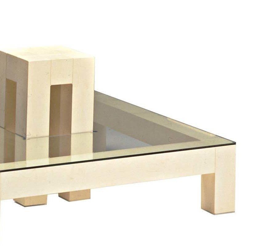 Constructed of a maple frame with a glass top, this striking piece showcases a smaller wooden table at its centre seemingly penetrating the glass surface of the larger one. This table measures 110 x 110 x 26 cm (the height of the inside table is 29