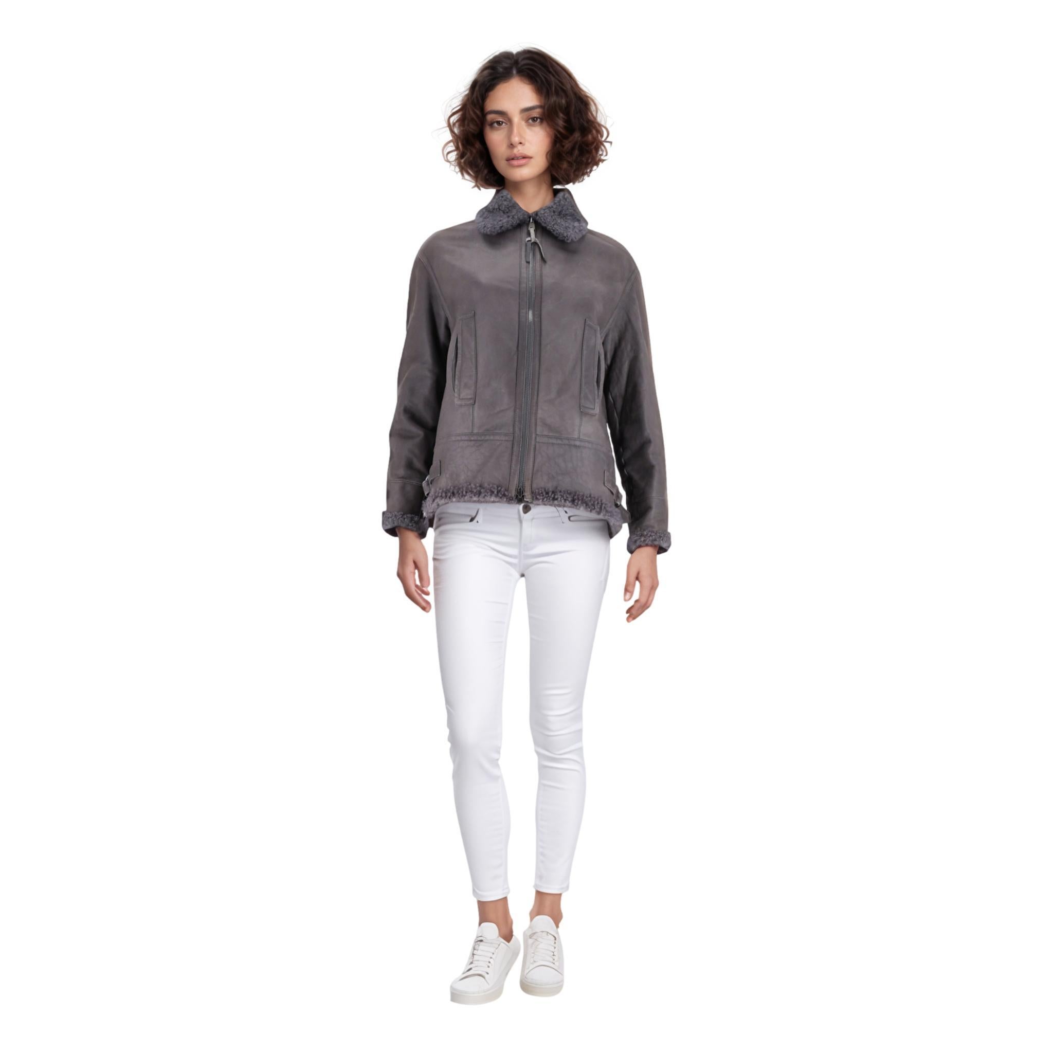 Brunello Cuccinelli Leather & Shearling Jacket

Grey aviator jacket featuring full shearling lining extending out at the hems and collar.

Detailed with the signature silver bead embellished zip and side pockets.

Size – 38IT

Condition – Good (Some