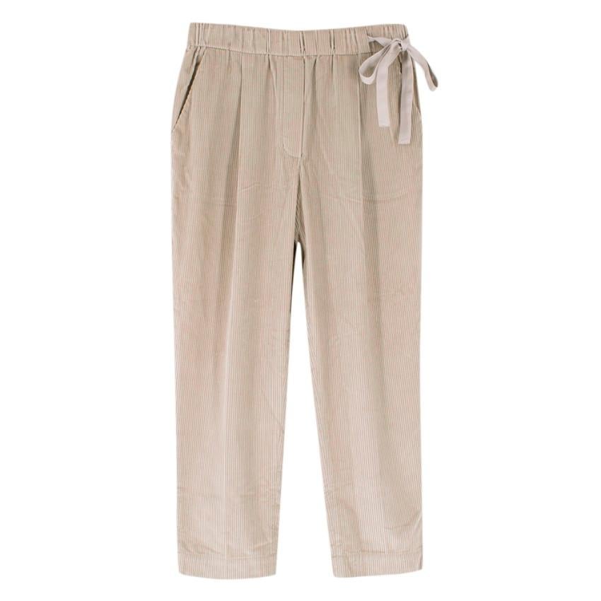 Brunello Cucinelli Beige Ribbed Velvet Cord Trouser

- loosely cut
- elastic waistband with drawstring made from silk ribbons
- Ribbons fall to left side
- two side pockets
- very soft fabric

Materials
- 92% cotton, 8% cashmere

Dry Clean