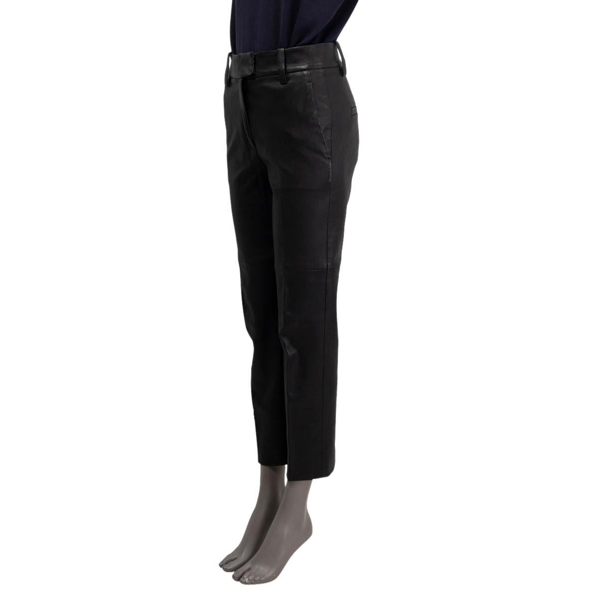 100% authentic Brunello Cucinelli high-waisted cropped trousers in black stretch leather (100%) with belt loops, two pockets on the sides, and two buttoned welt-pockets on the back. Close on the front with with a zipper and hook fastener. Lined in