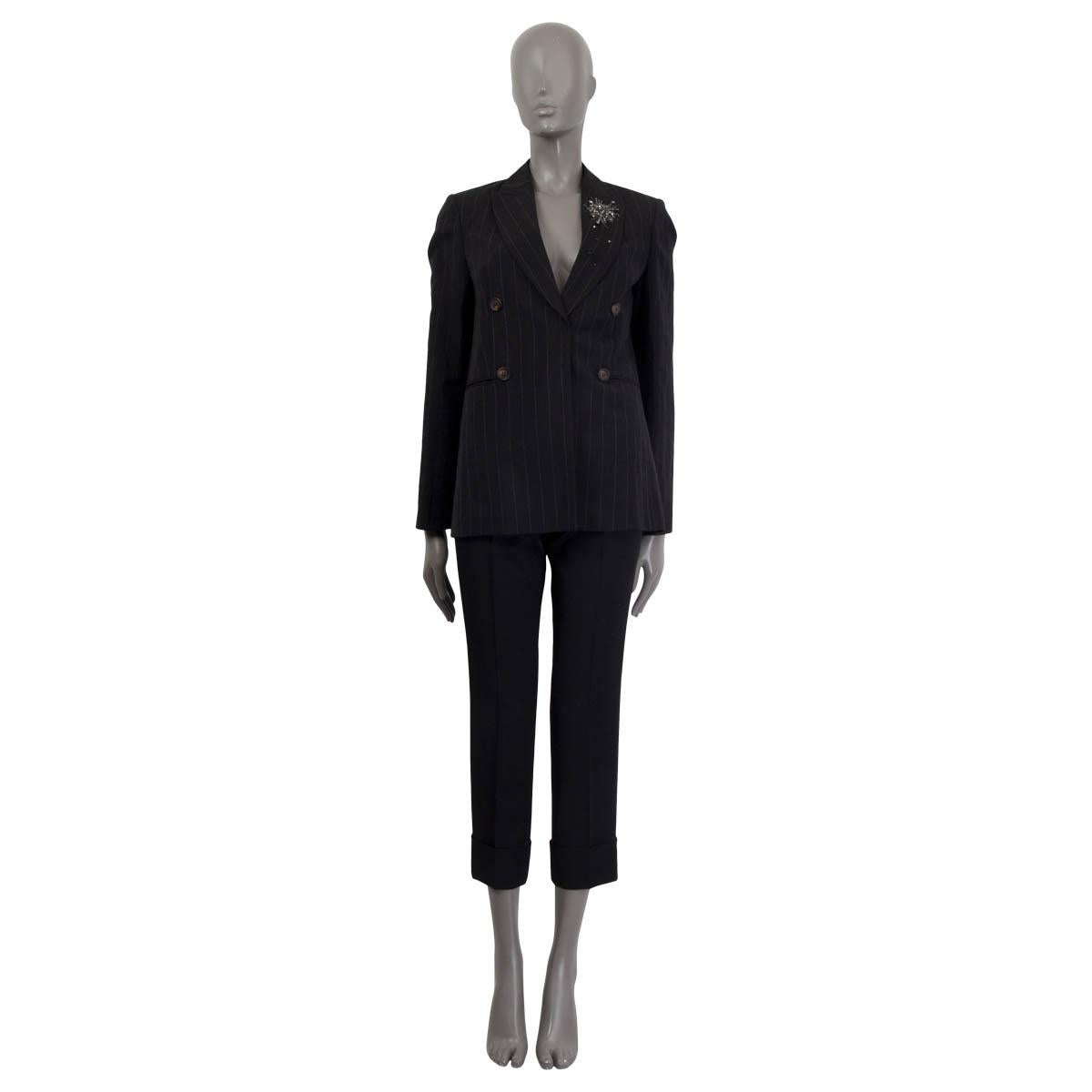100% authentic Brunello Cucinelli pin-stripe blazer in black a gray virgin wool (54%) and linen (46%). Features Swarovski crystal embellishments on the collar and two sewn shut slit pockets on the front. Opens with two push buttons on the front.