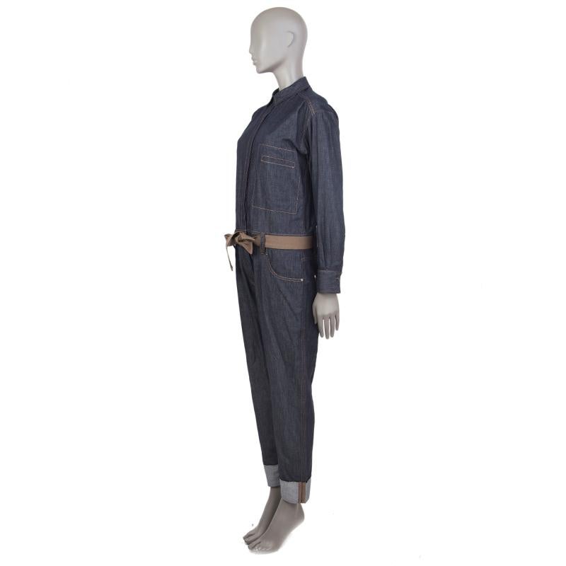 100% authentic Brunello Cucinelli belted denim jumpsuit in dark blue cotton (100%) with a straight collar, one-button cuffs, belt loops, classic five-pockets, and rolled-up embellished pant-cuffs. The pant-part closes with a concealed zipper and a