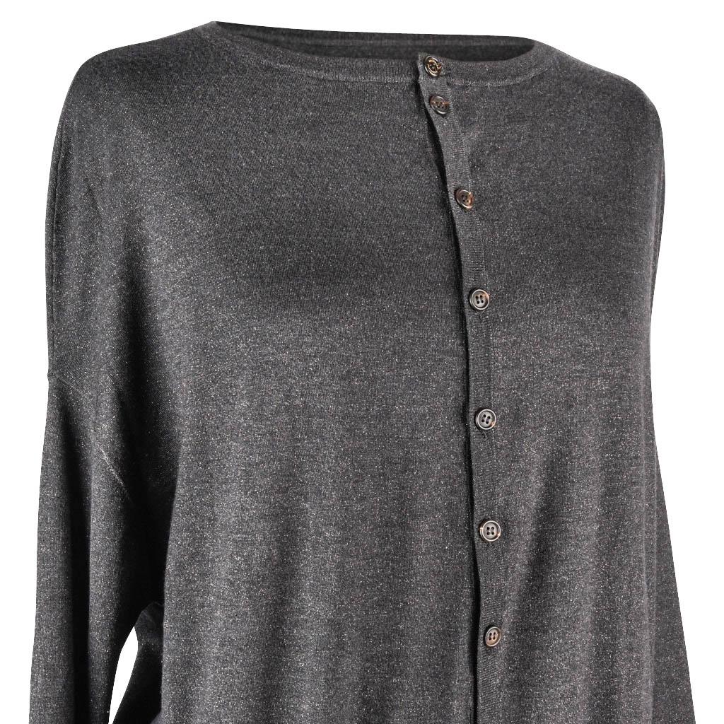 Guaranteed authentic Brunello Cucinelli gray drop shoulder cardigan.
Bold rear step hem.
Light weight knit with a subtle coppery metallic thread running through the fabric.
The sweater is elegantly oversized and has a ribbed crew neck, cuff and hip.