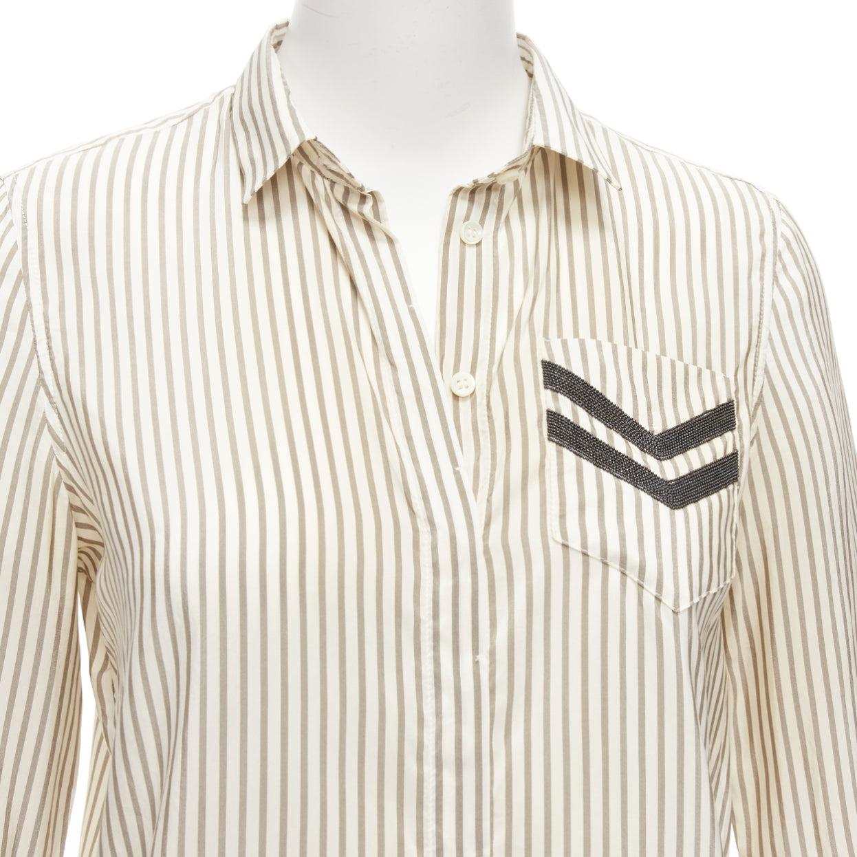 BRUNELLO CUCINELLI cream grey stripe black V beaded pocket dress shirt XS
Reference: EALU/A00007
Brand: Brunello Cucinelli
Material: Silk
Color: Grey, Cream
Pattern: Striped
Closure: Button
Made in: Italy

CONDITION:
Condition: Poor, this item was