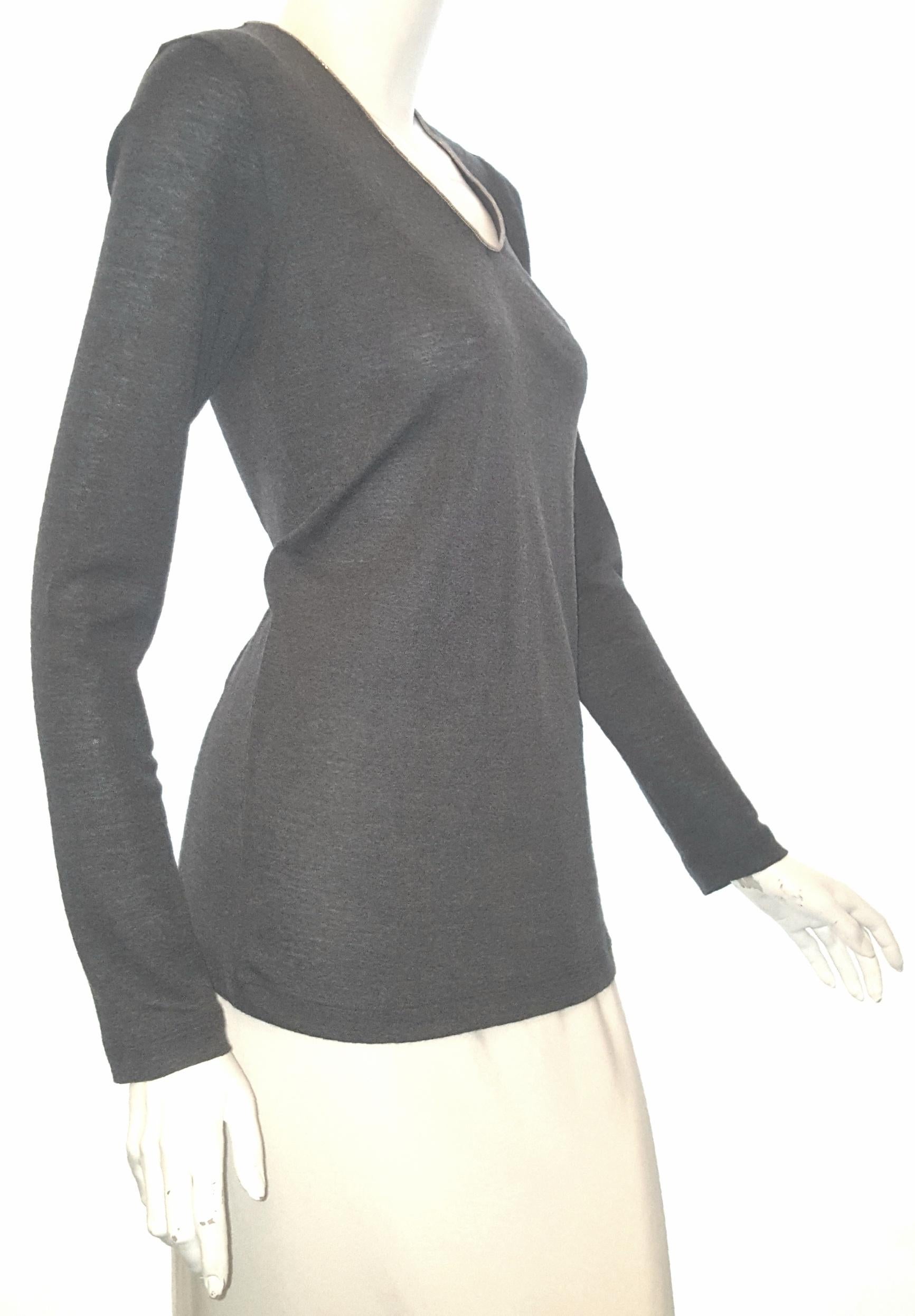 Brunello Cucinelli grey pullover sweater includes Monili paillette around bateau neckline.  The long sleeves have knit cuffs.  This sweater is not lined and is in excellent condition.  This slim fit, pullover style composed of virgin wool/spandex.  